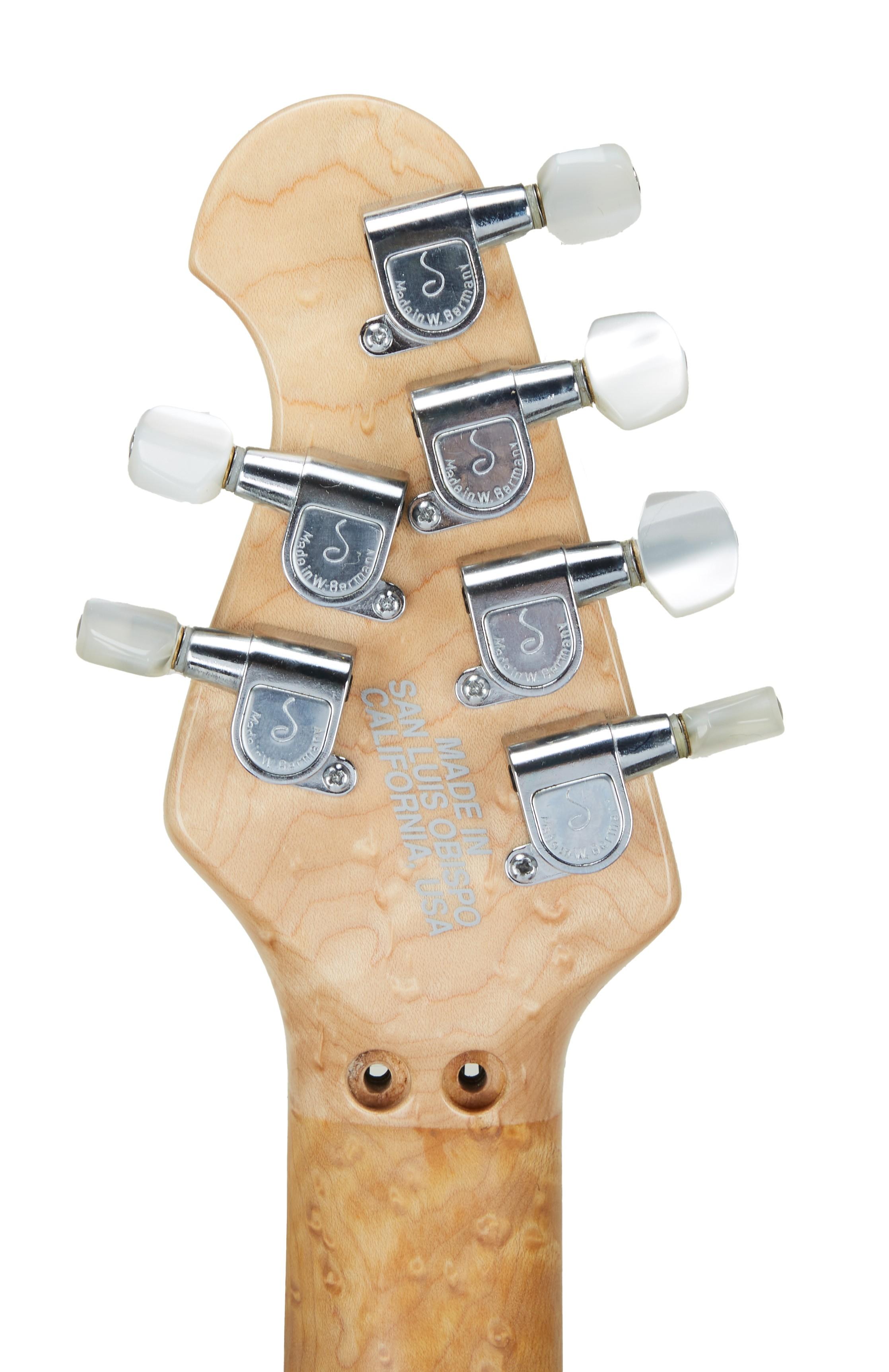 a close up of a guitar headstock that says made in california