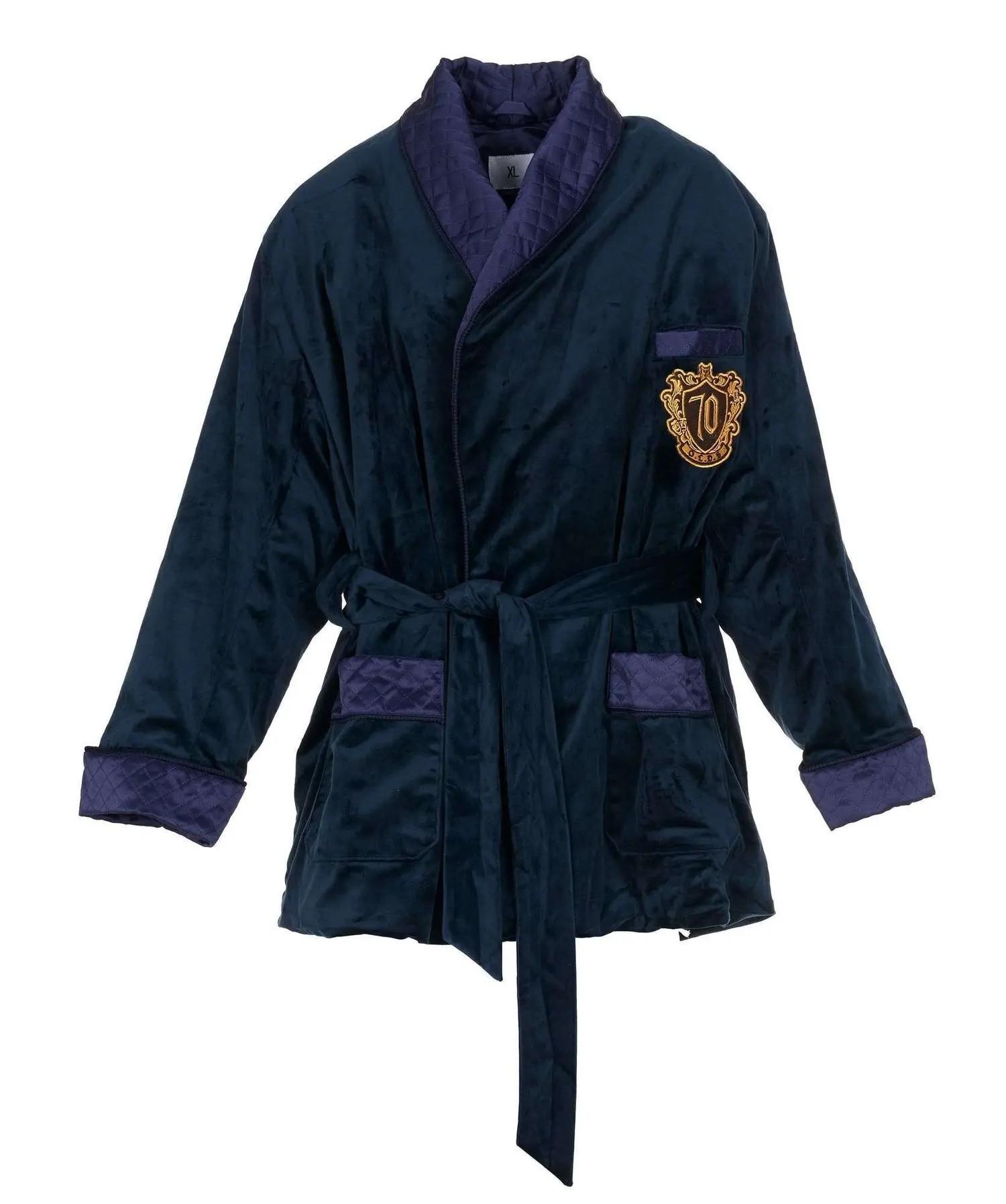 A dark blue velvet smoking jacket with purple quilted trim, a tied waist, and a gold "70" crest on the chest.