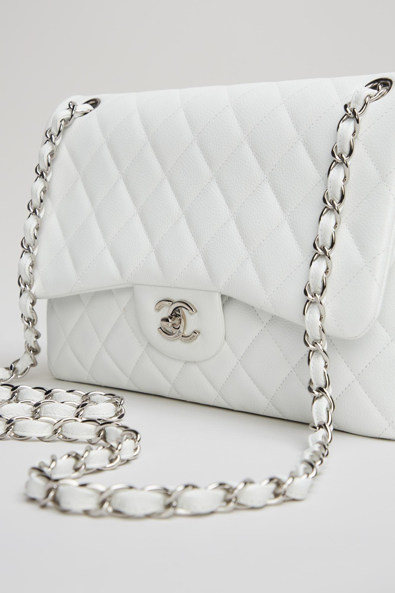 a white chanel purse with a silver chain