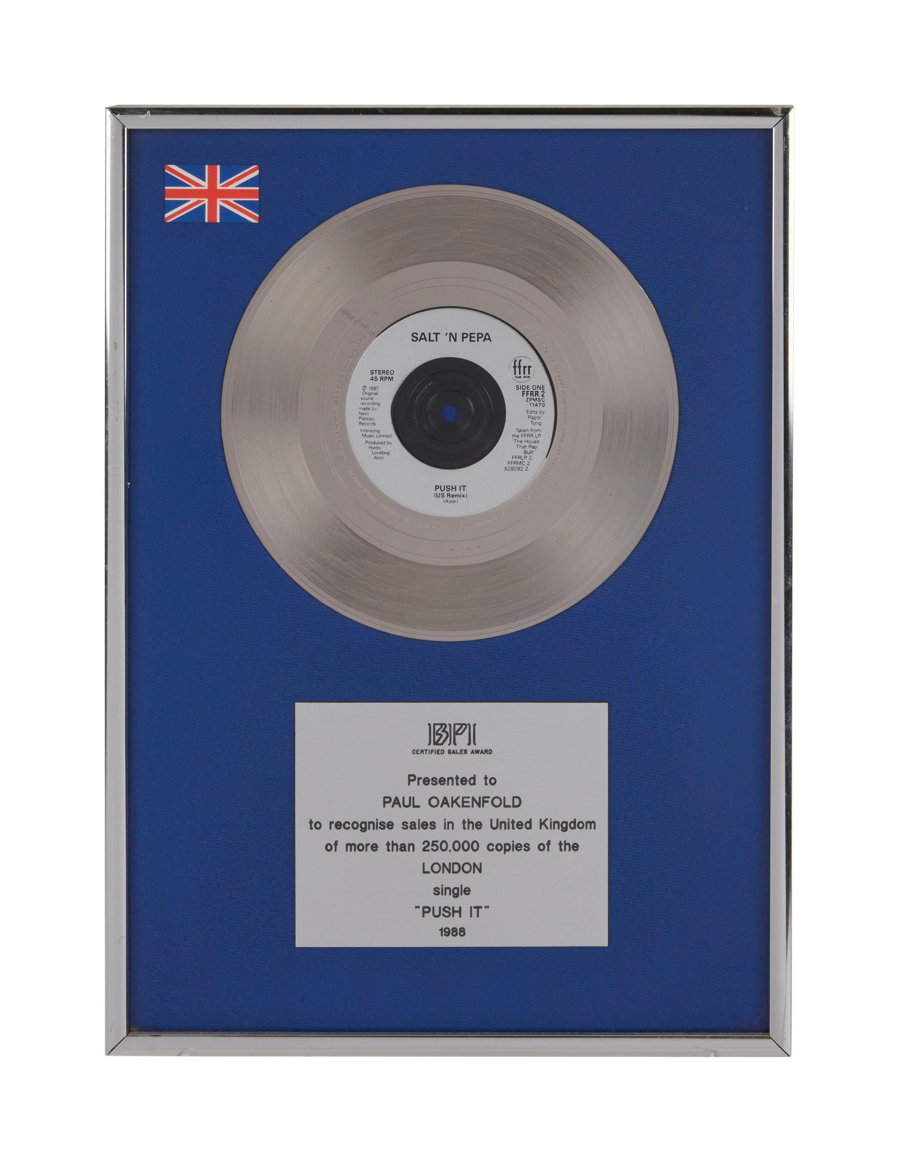 a silver record in a blue frame that says push it