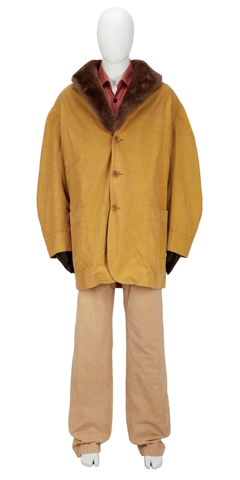a mannequin wearing a yellow jacket and tan pants