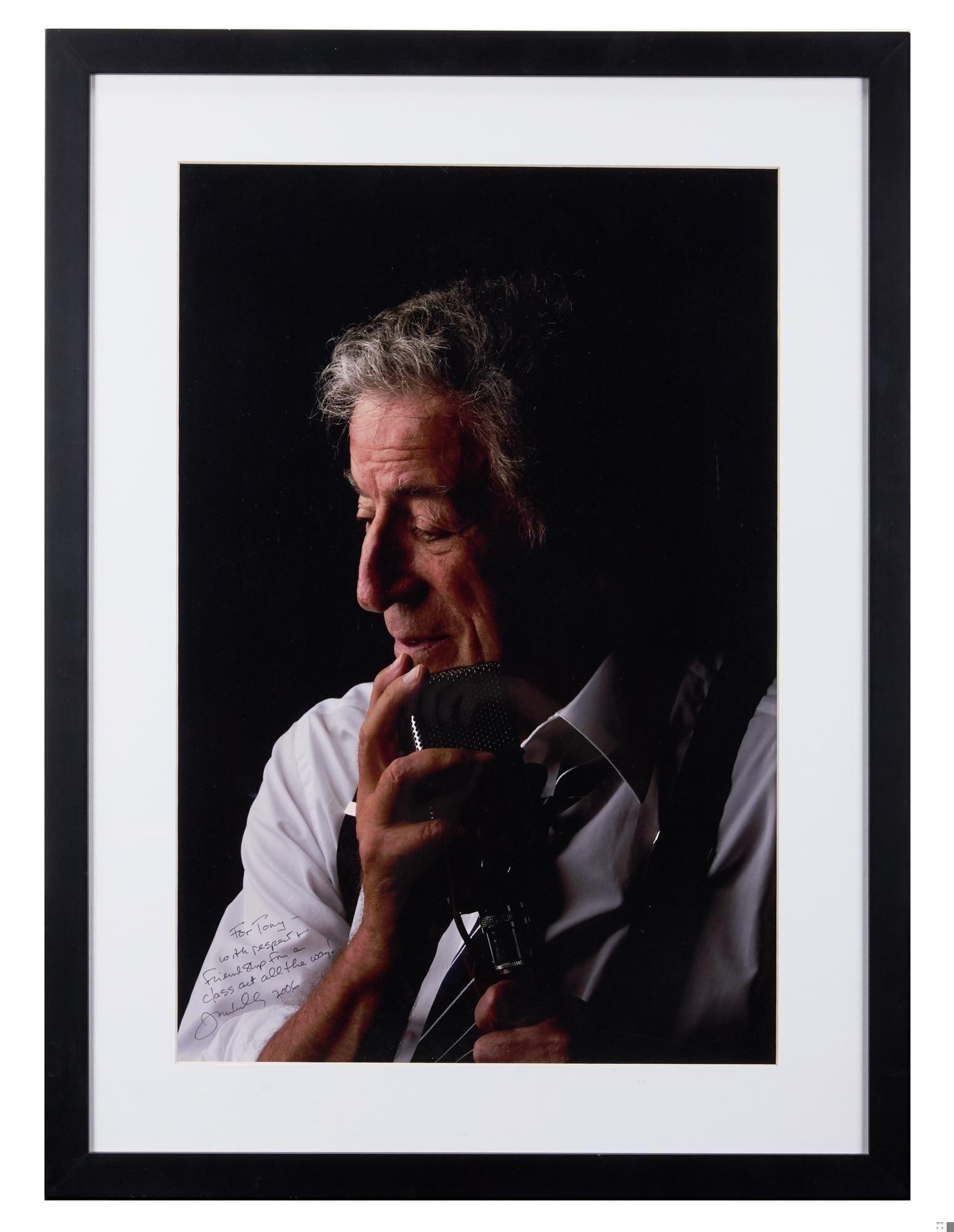 a framed picture of a man holding a microphone