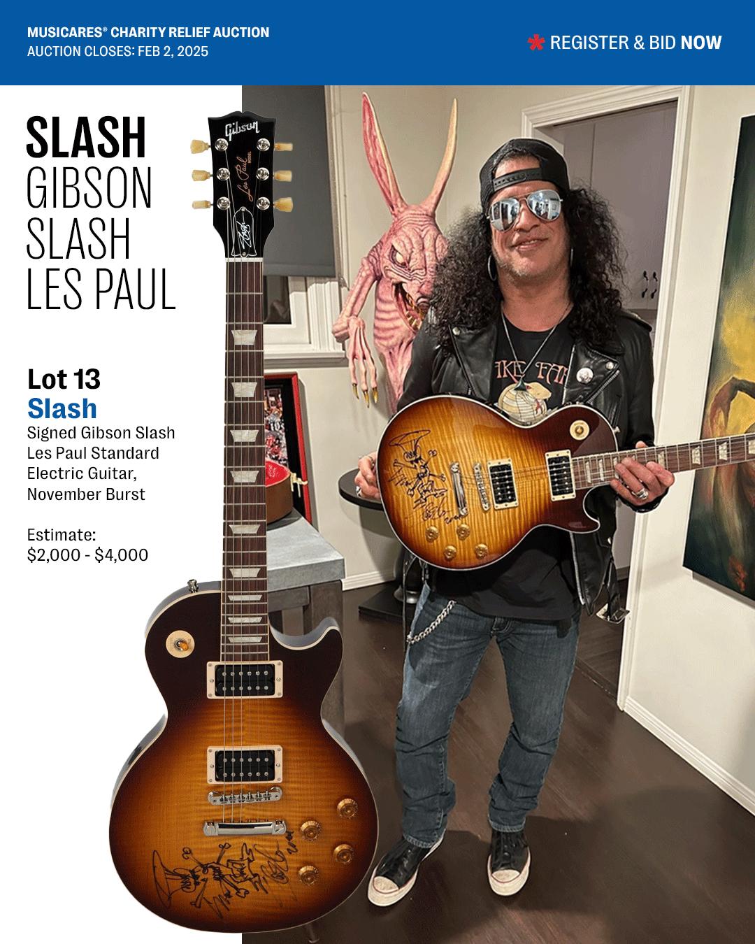 a man holding a guitar that is signed by slash