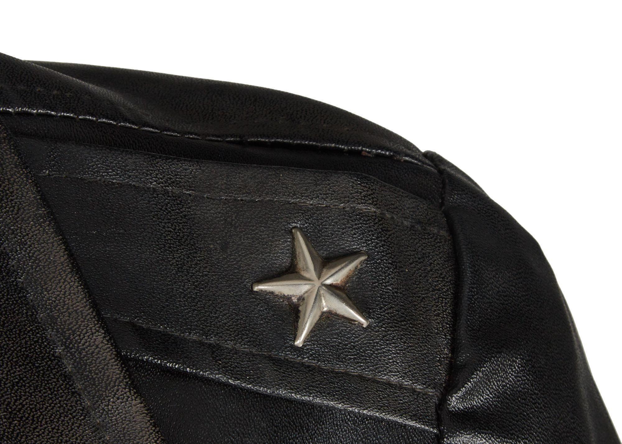 a close up of a black leather jacket with a star on the shoulder .