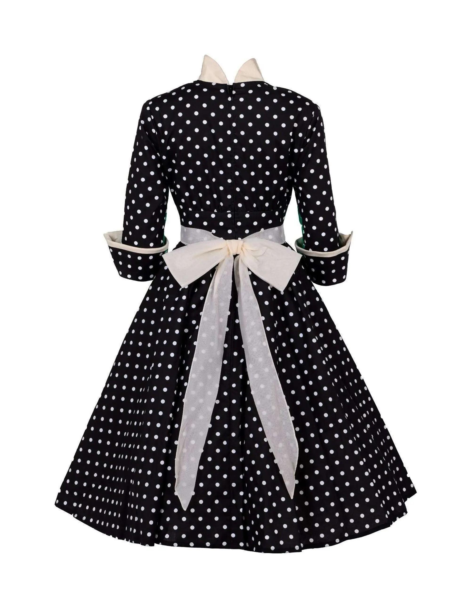 Back view of a black polka dot dress with a cream collar and a large cream bow.