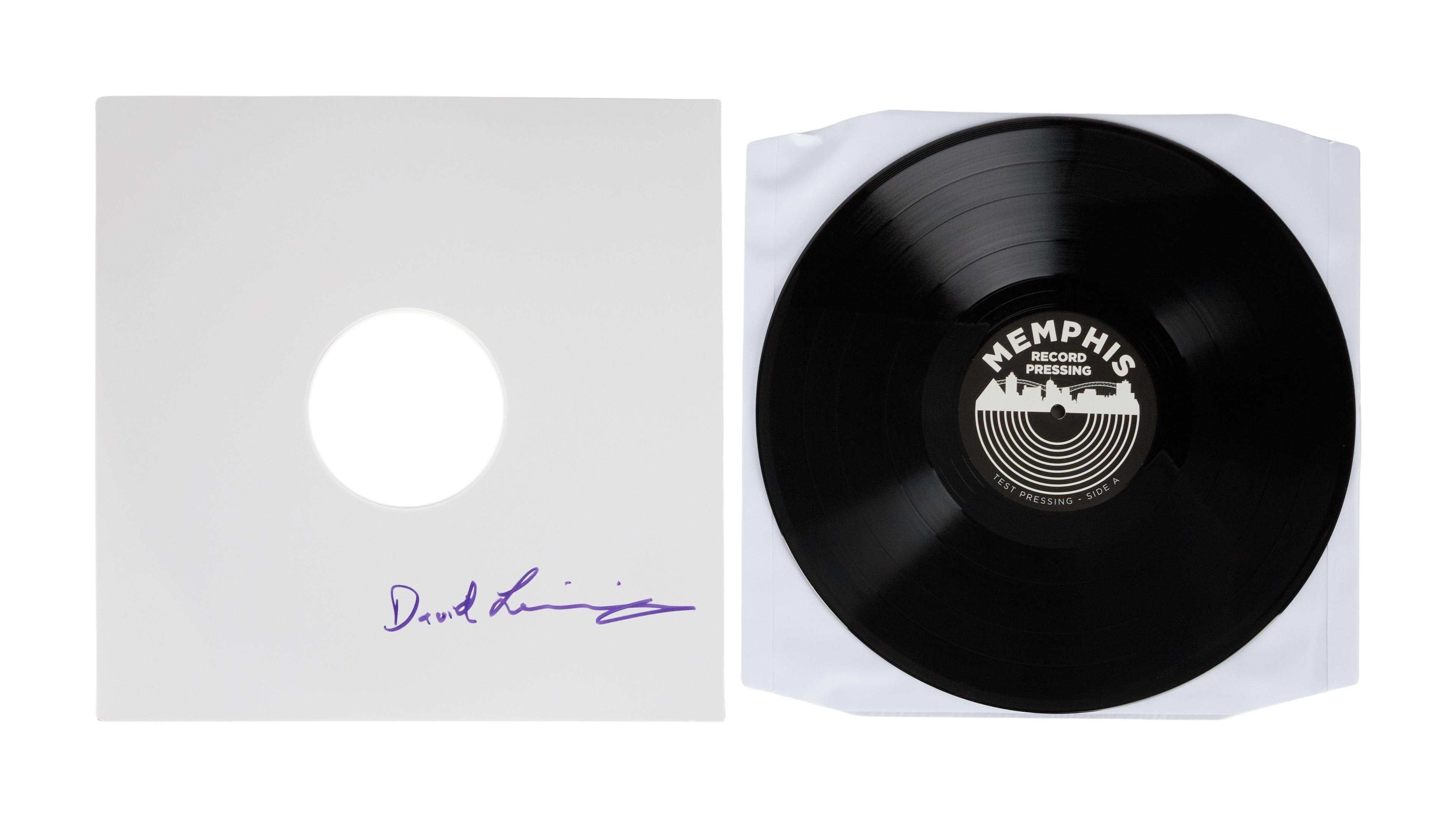 a black record with a white cover and a signature on it .