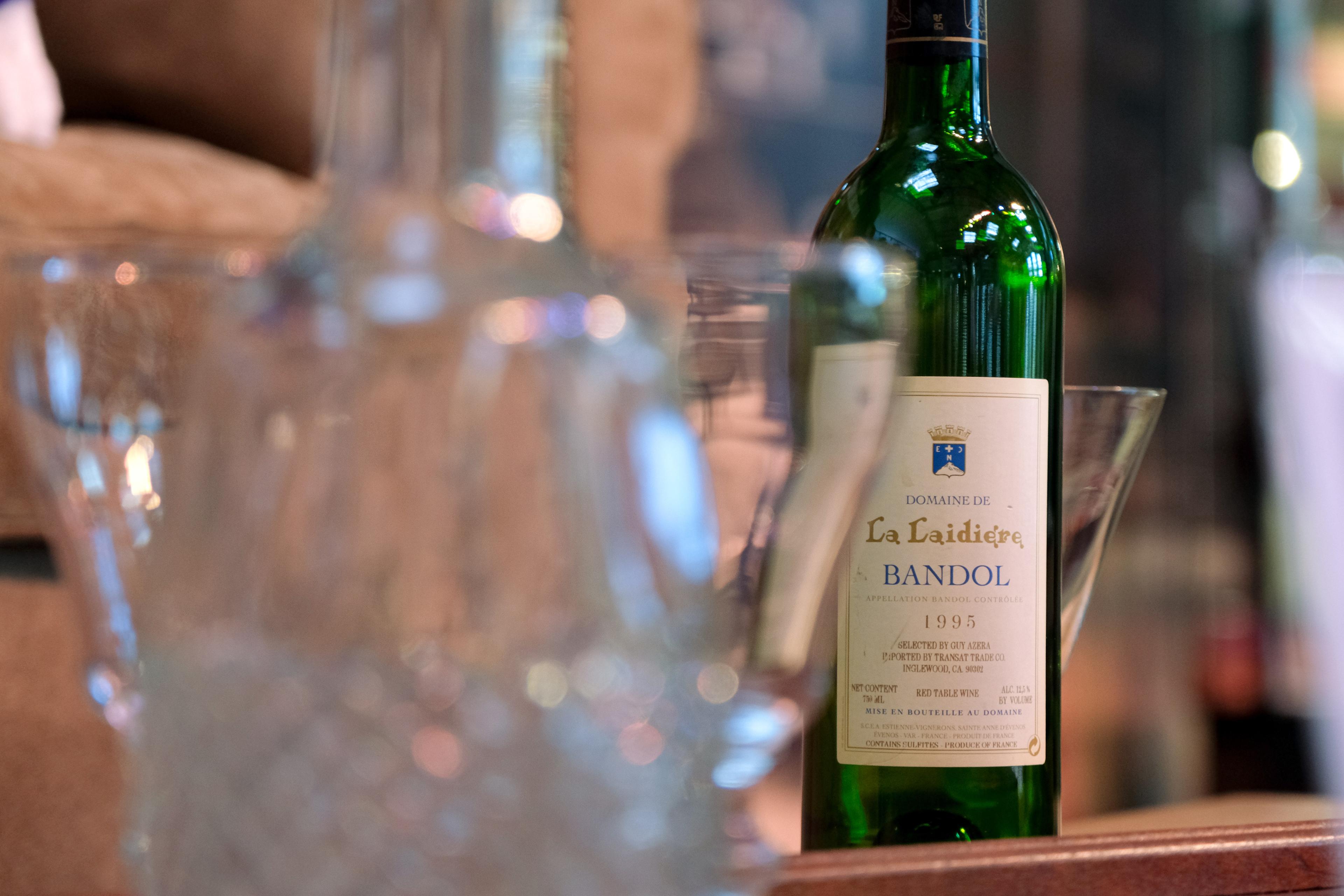 a bottle of wine with glass cups