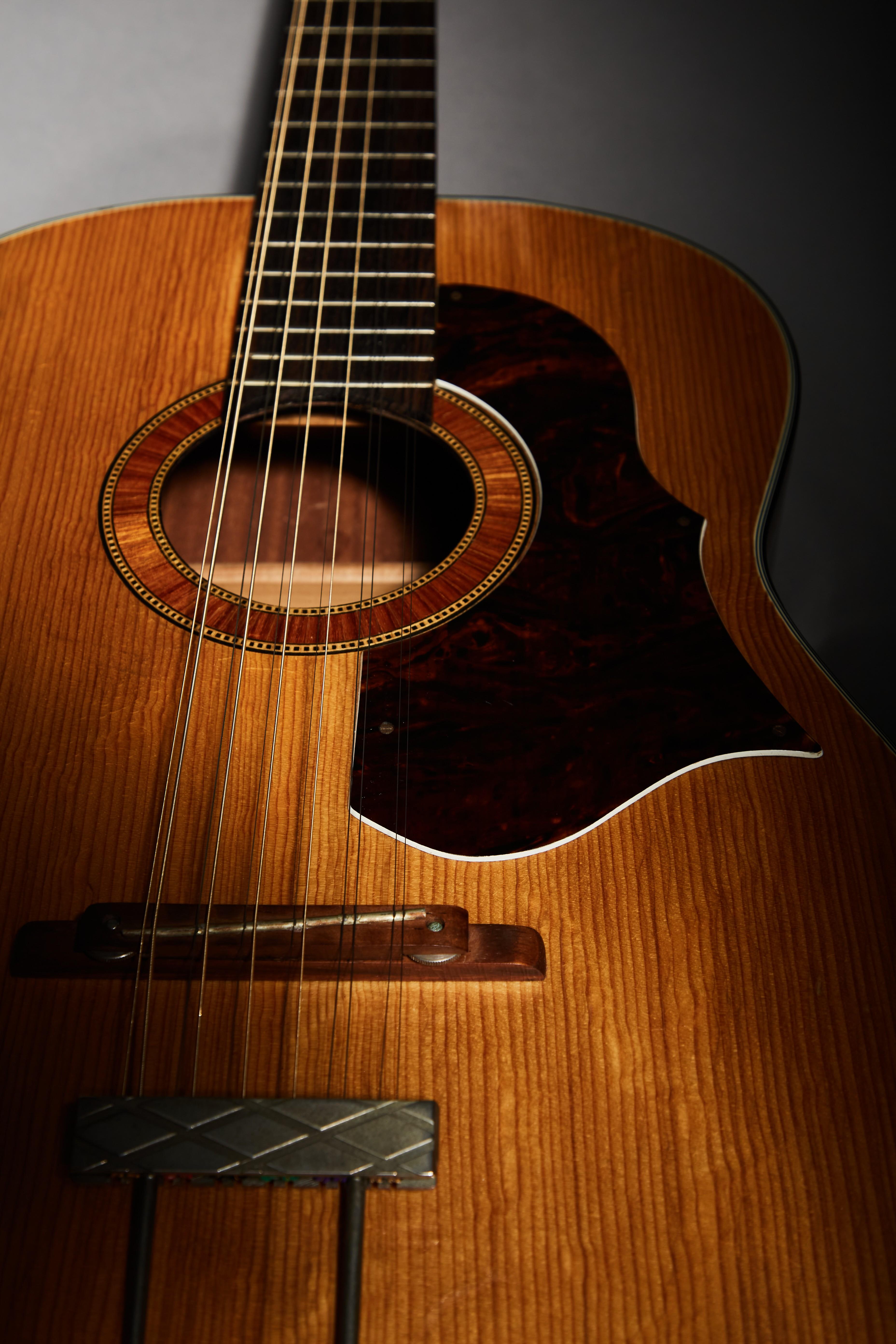 a close up of an acoustic guitar with a circle in the middle
