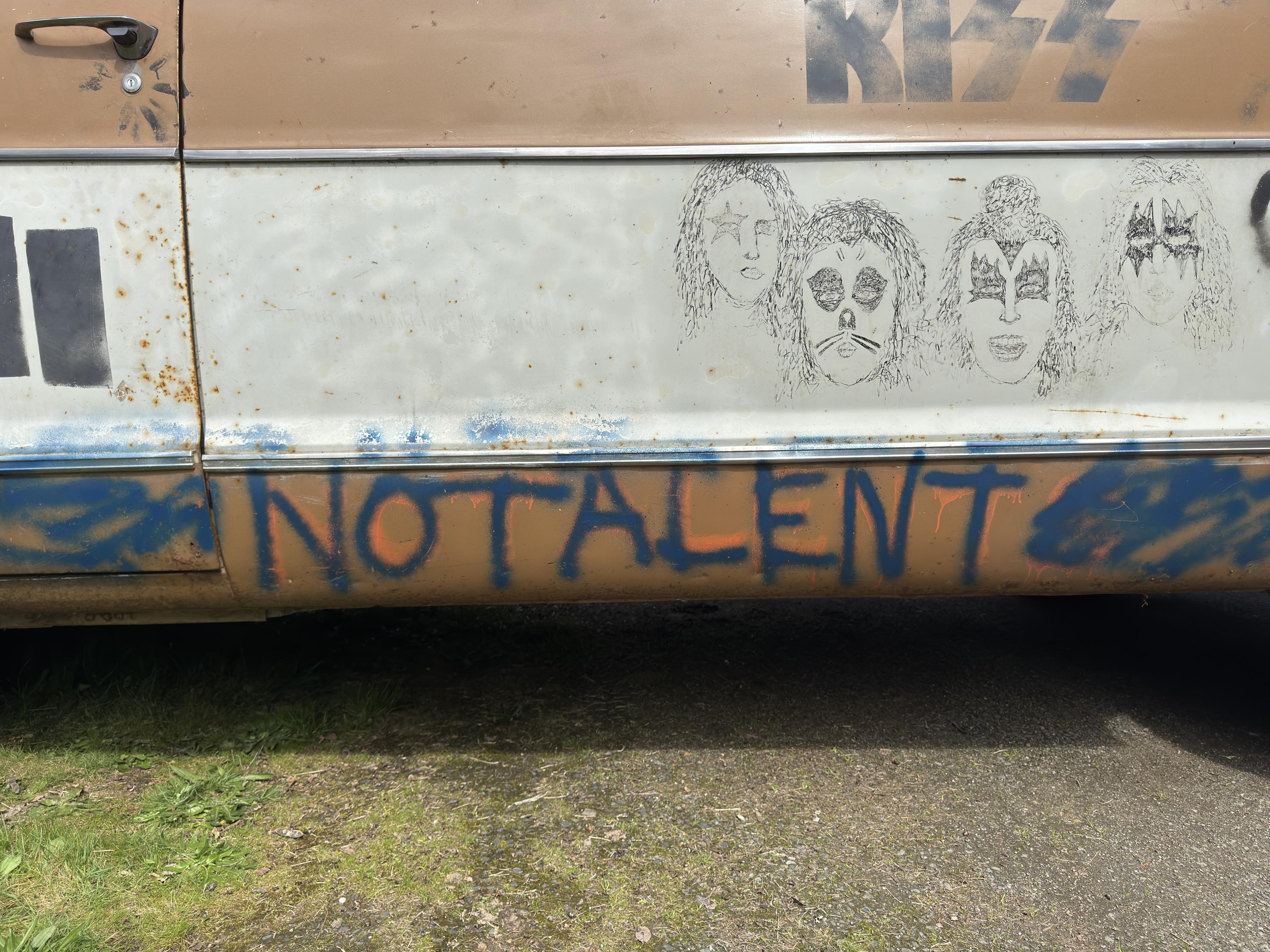 no talent is spray painted on the side of a van