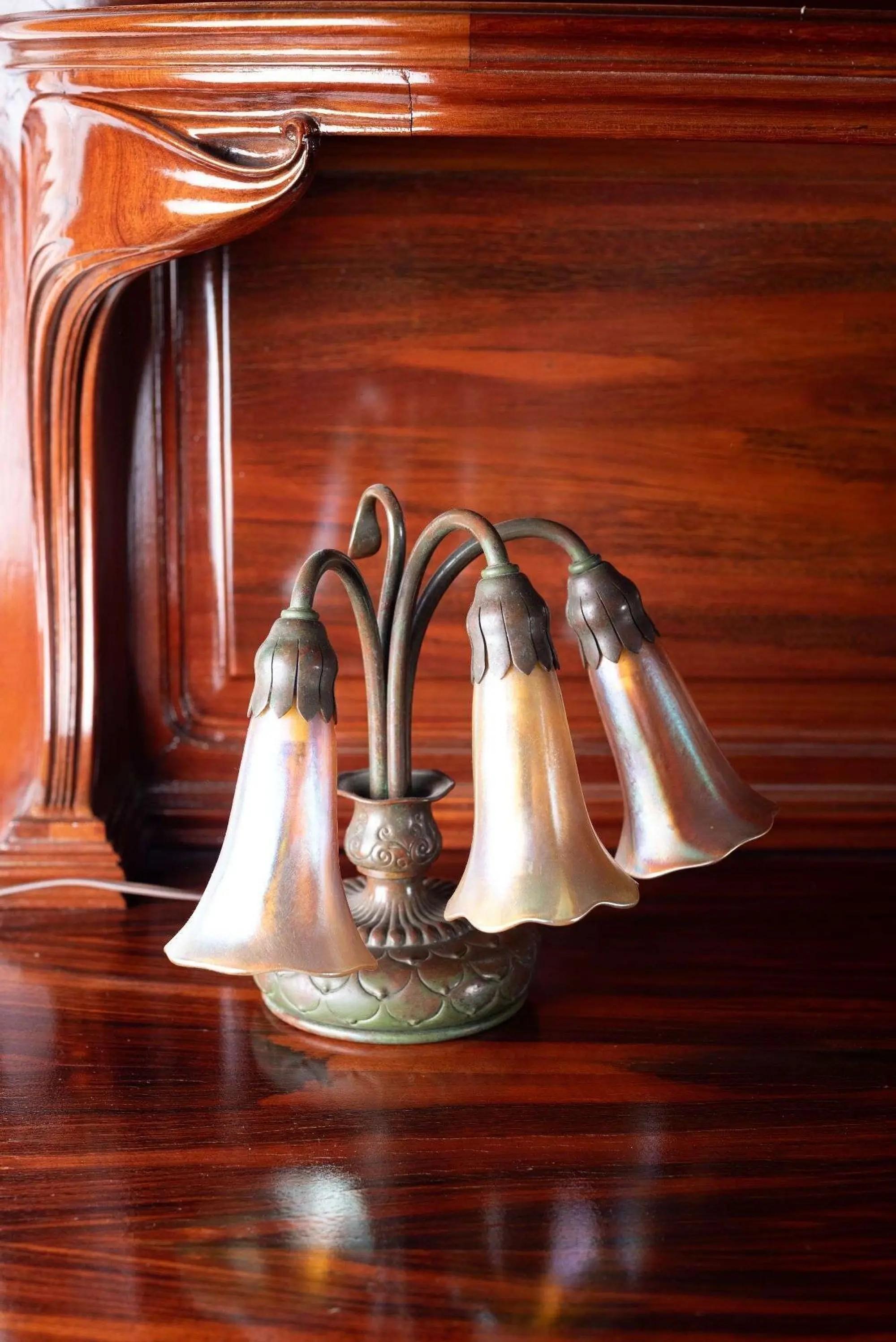 Lot #309. Whoopi Goldberg | Pair of Tiffany Studios Three-Light Pond Lily Piano Lamps Tiffany Studios Three-Light Pond Lily Piano Lamps