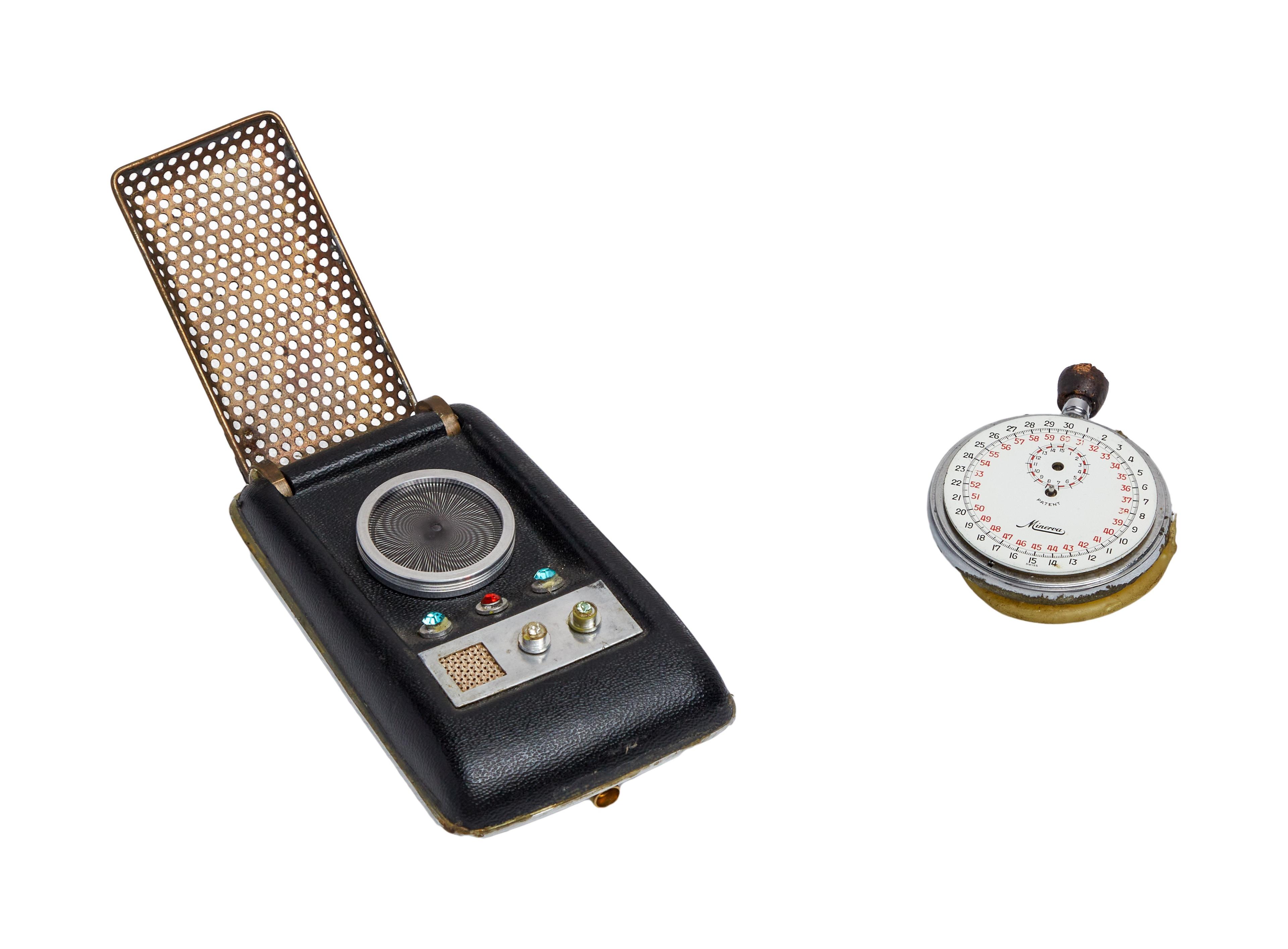 a cell phone and a stopwatch are sitting next to each other on a white background .