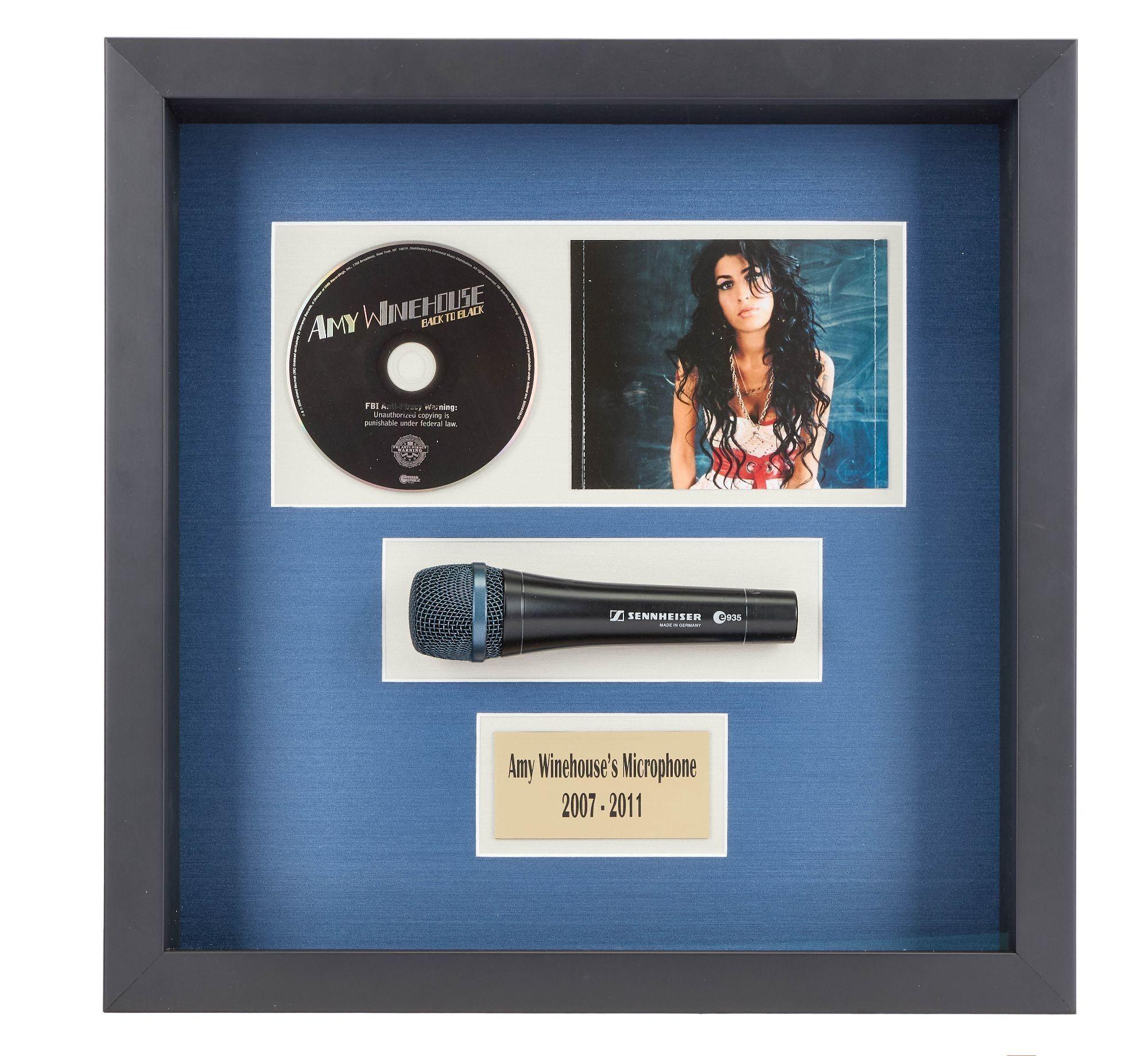 a framed display of amy winehouse 's microphone and cd .