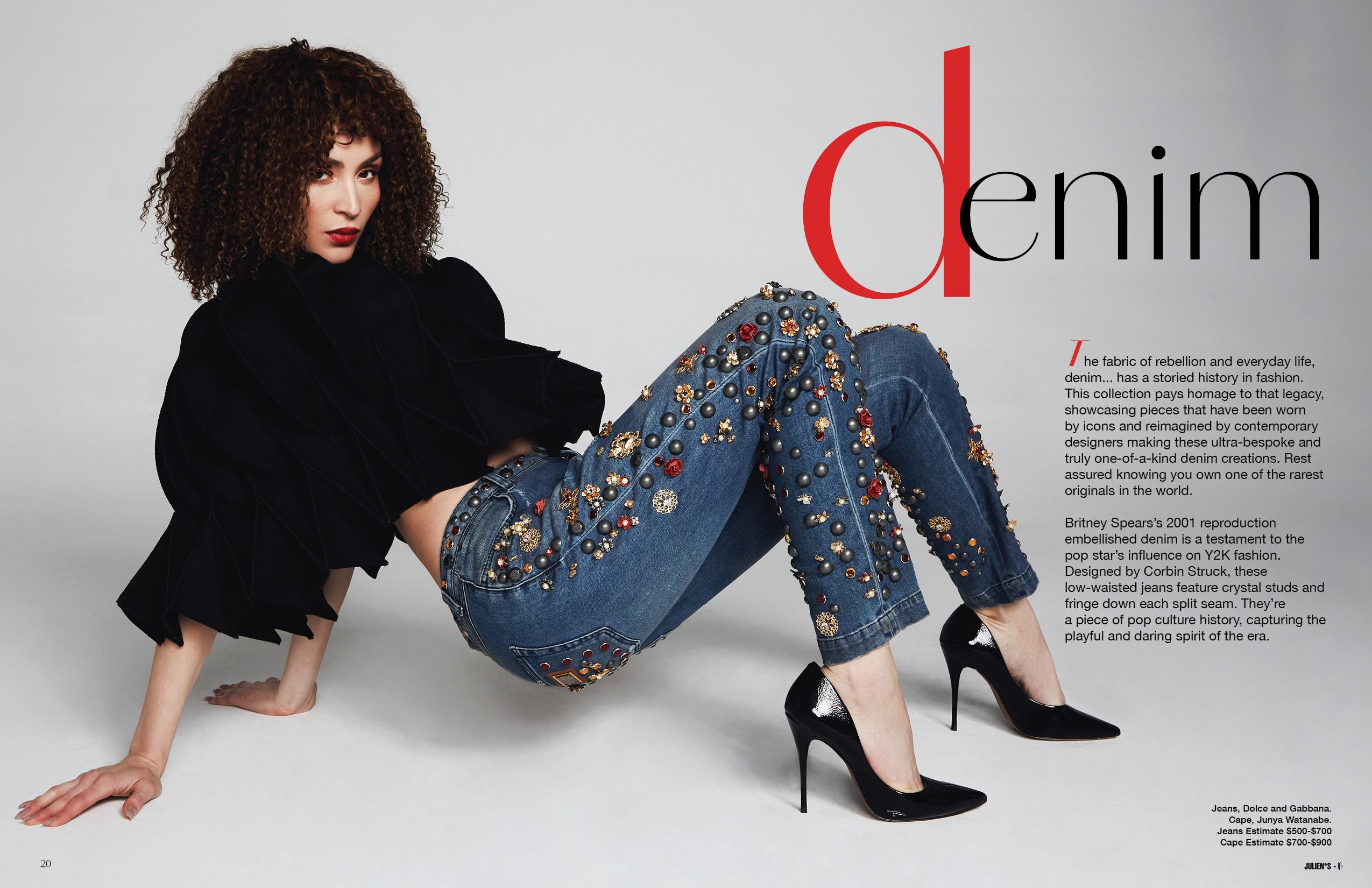 a woman is kneeling on the floor wearing a pair of jeans with rhinestones on them .