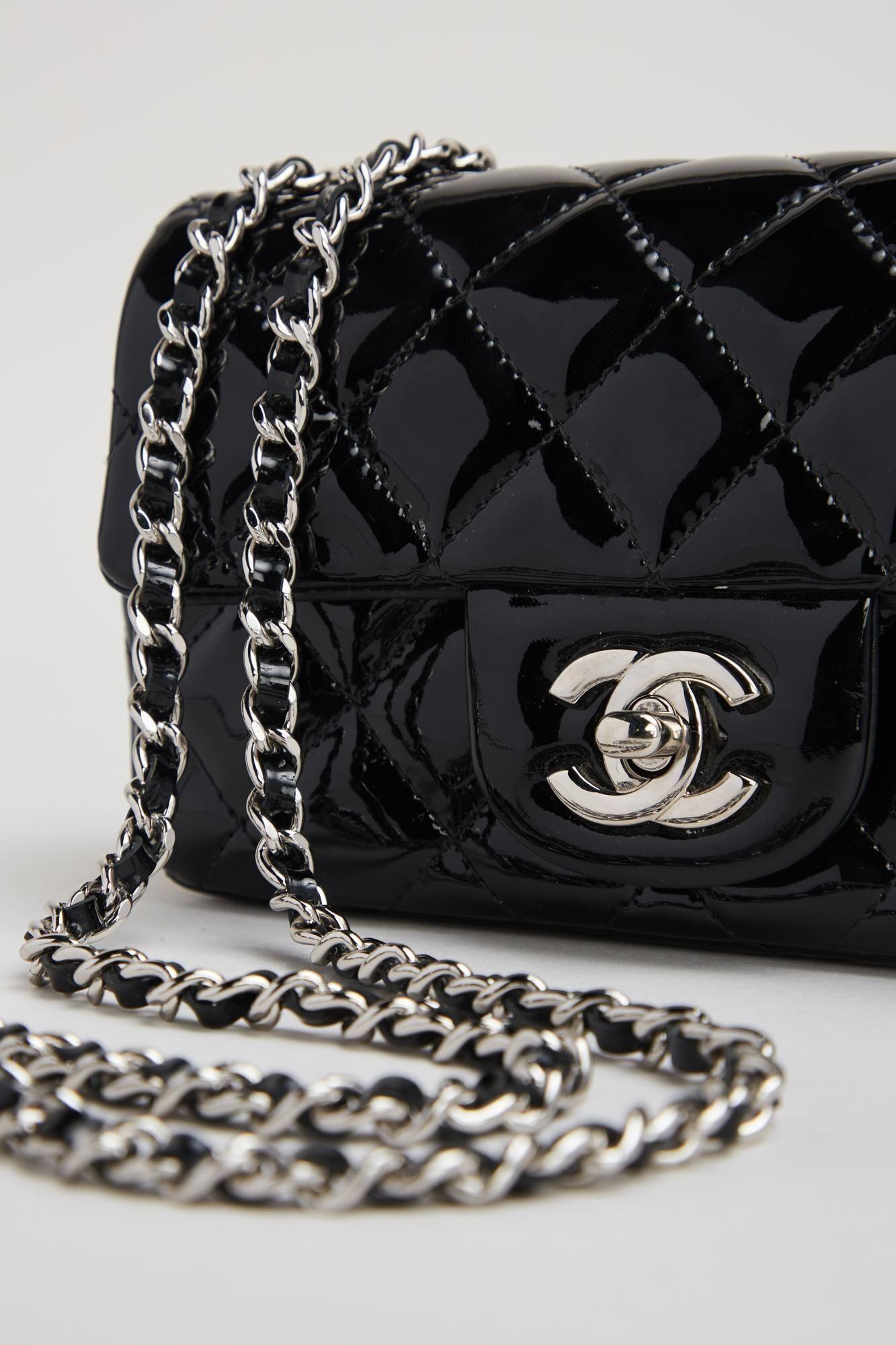 a black chanel purse with a silver chain