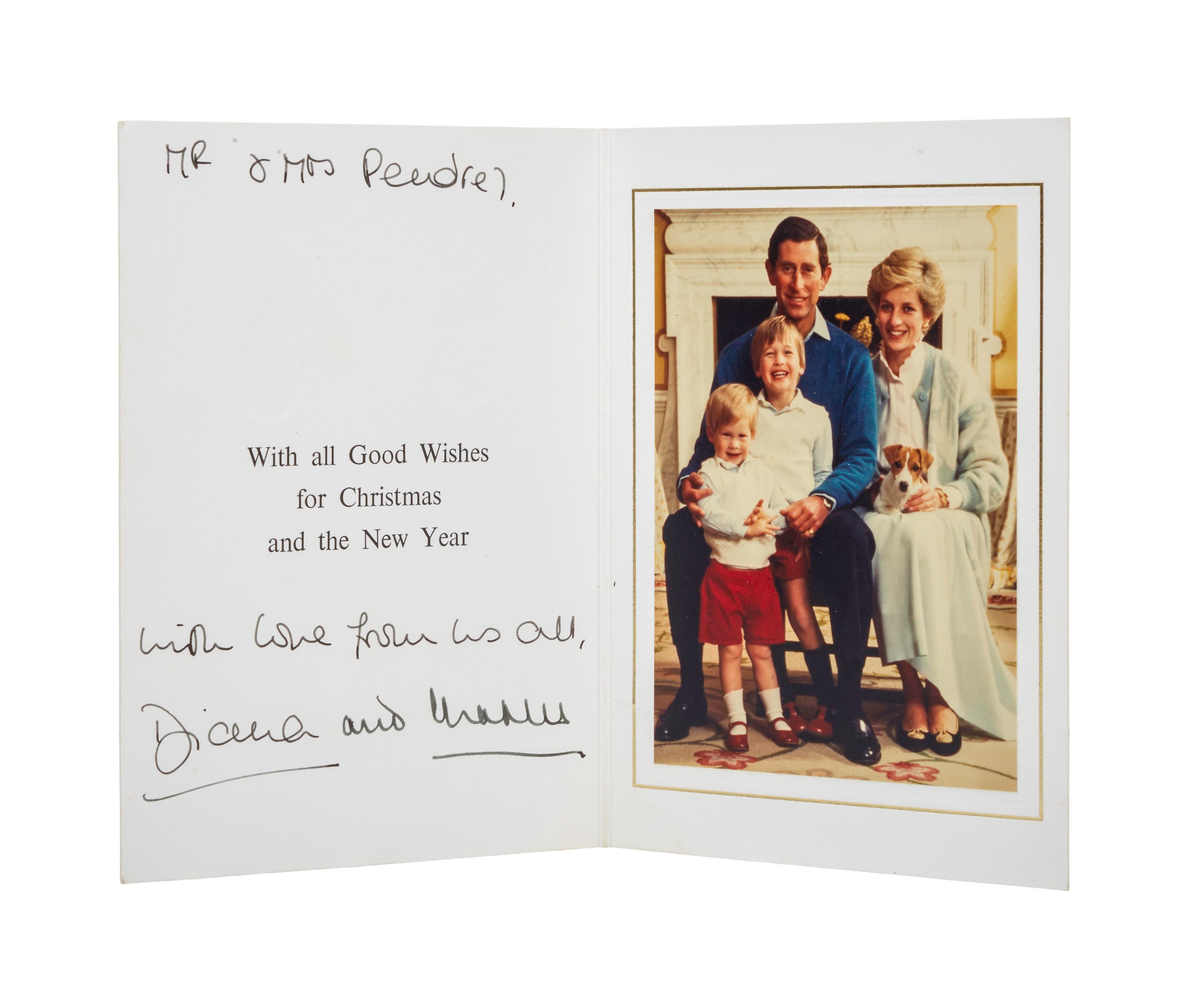 a christmas card with a picture of a family and a dog .
