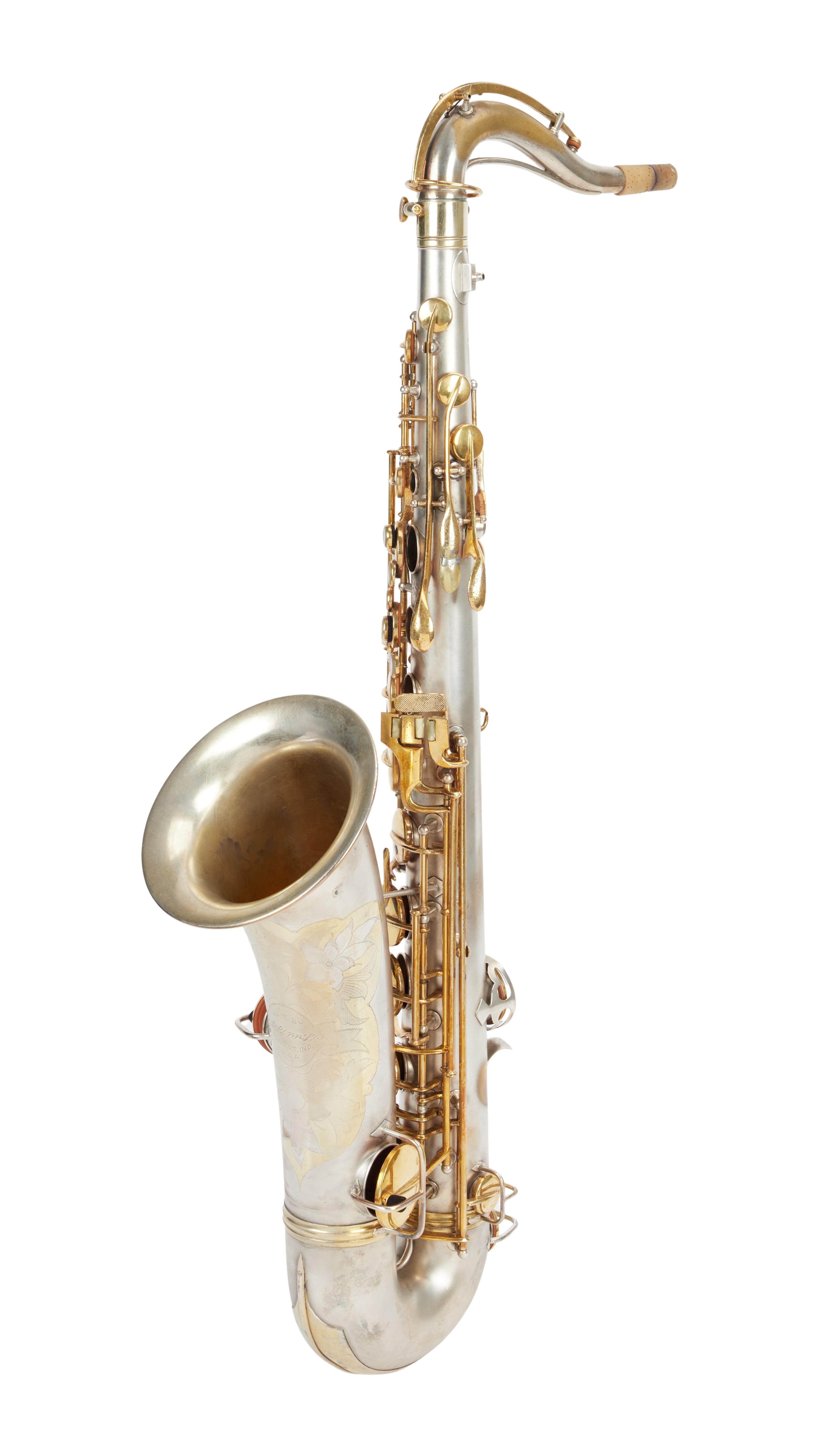 Silver saxophone with gold keys and engraved details.