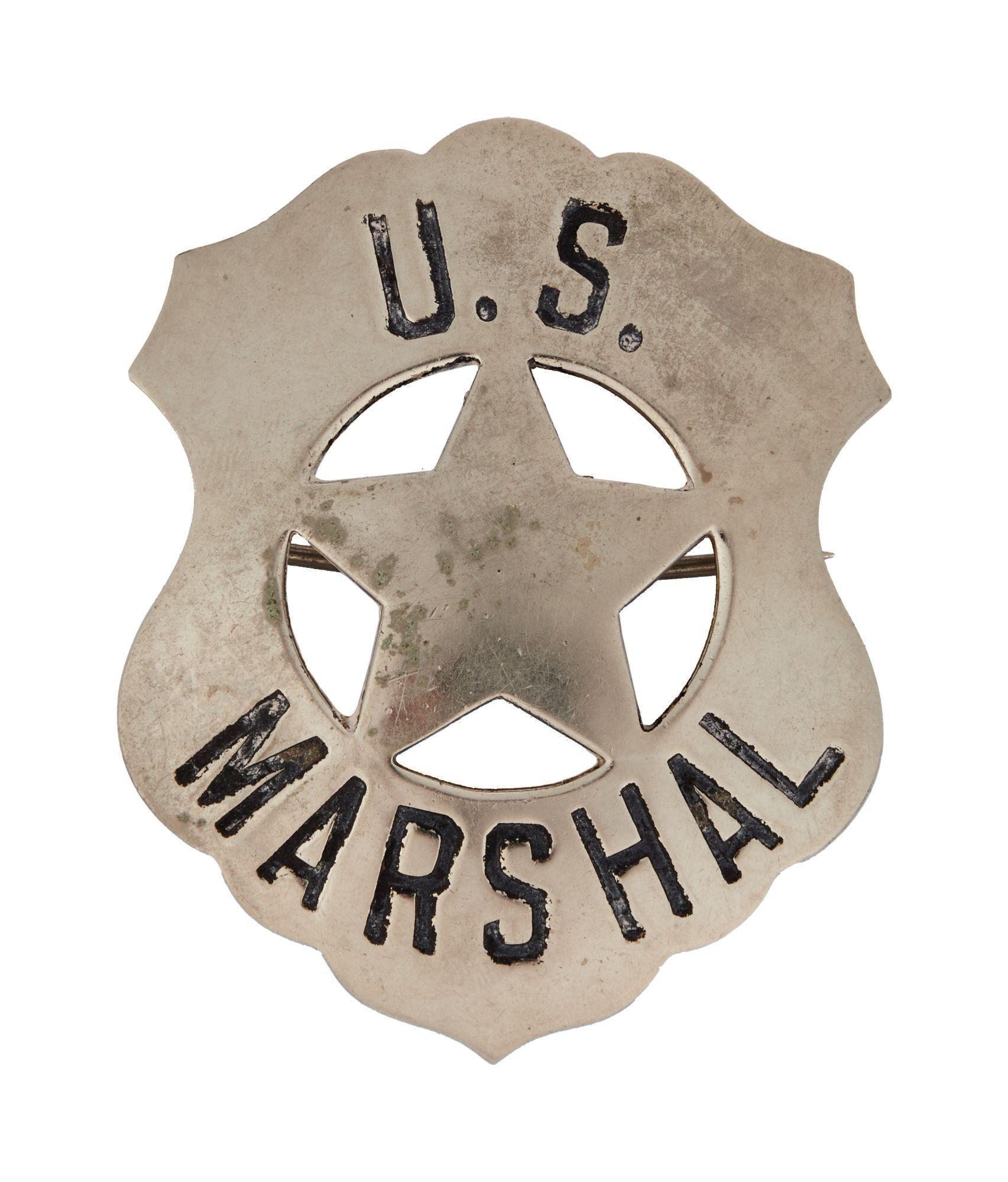 a silver u.s. marshal badge with a star in the center