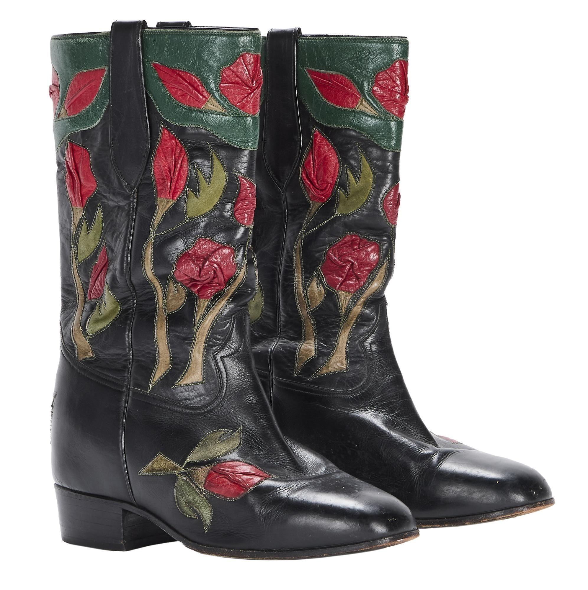 Lot #321. Burt Reynolds | Roses Cowboy Boots a pair of black leather cowboy boots with red and green flowers on them .