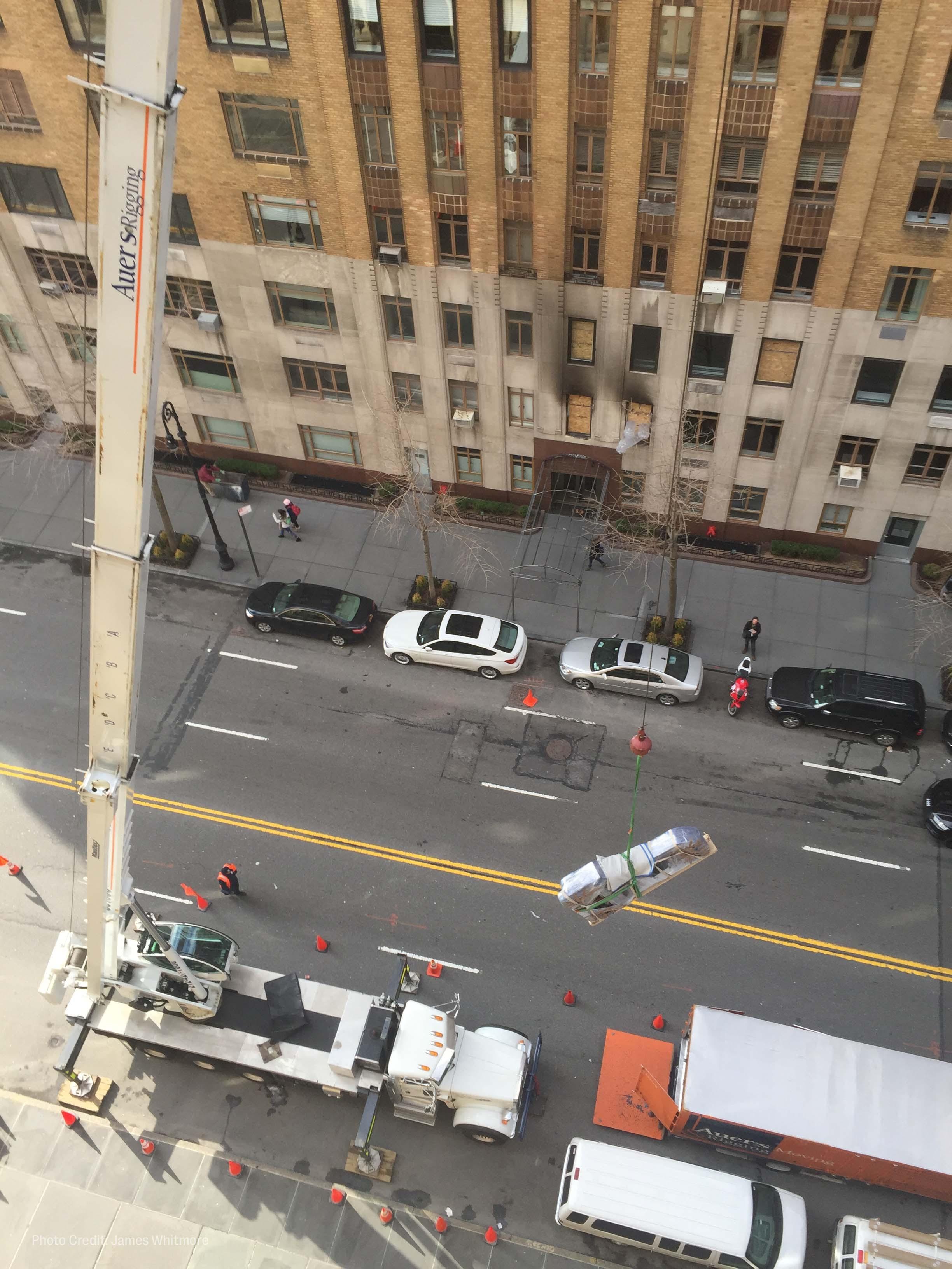 workers hoist roberta flack's piano out of her new york city apartment window.