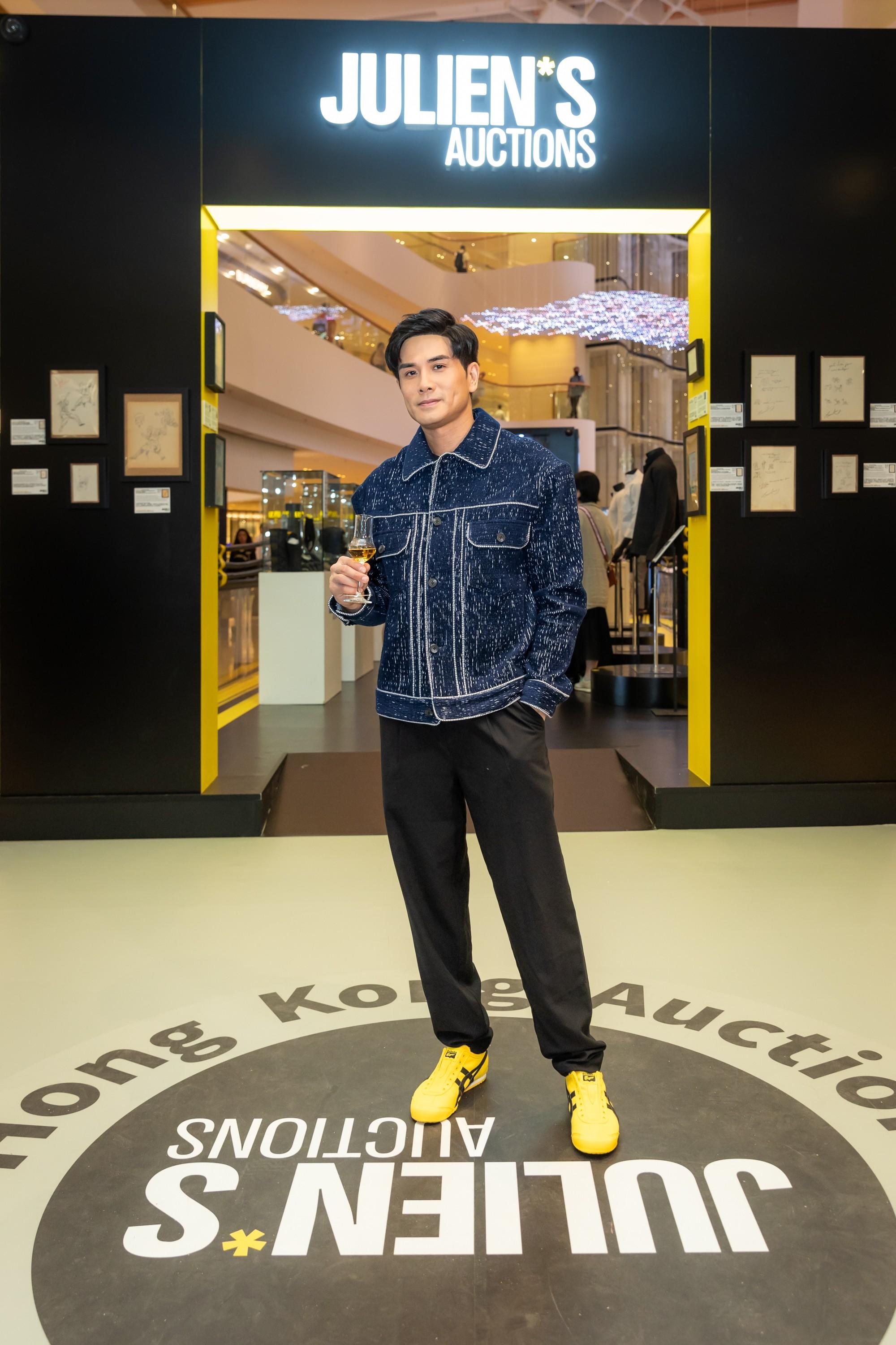 Actor Philip Ng, who played Bruce Lee in "Birth of the Dragon," visits Julien's Auctions 'Legends in Motion' special exhibition at Pacific Place in Hong Kong. (Credit: Instagram - straightblast5) a man stands in front of a julien 's auctions sign