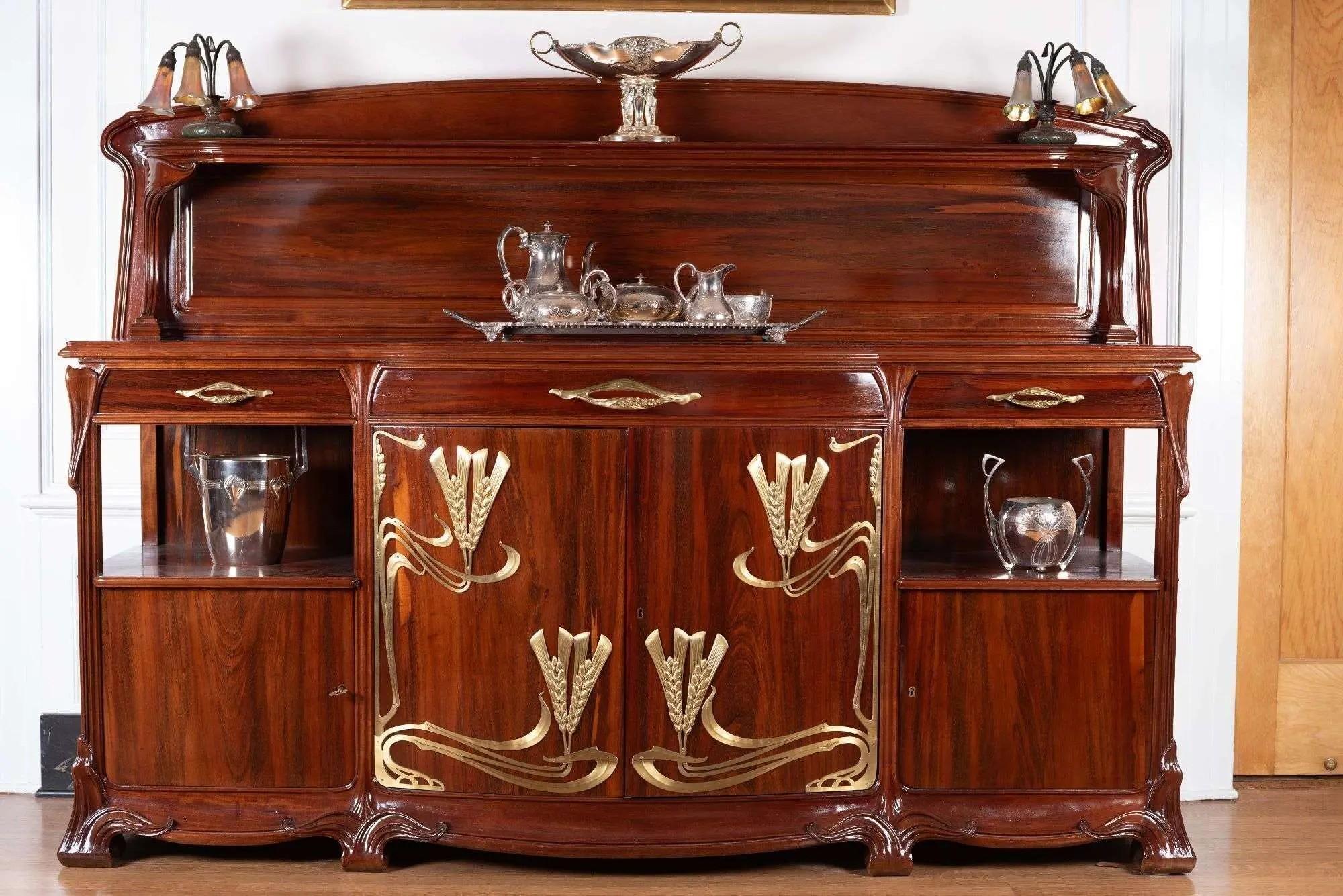 Lot #290. Whoopi Goldberg | Louis Majorelle Epis de Ble Dining Suite a wooden dining suite with gold tone accents
