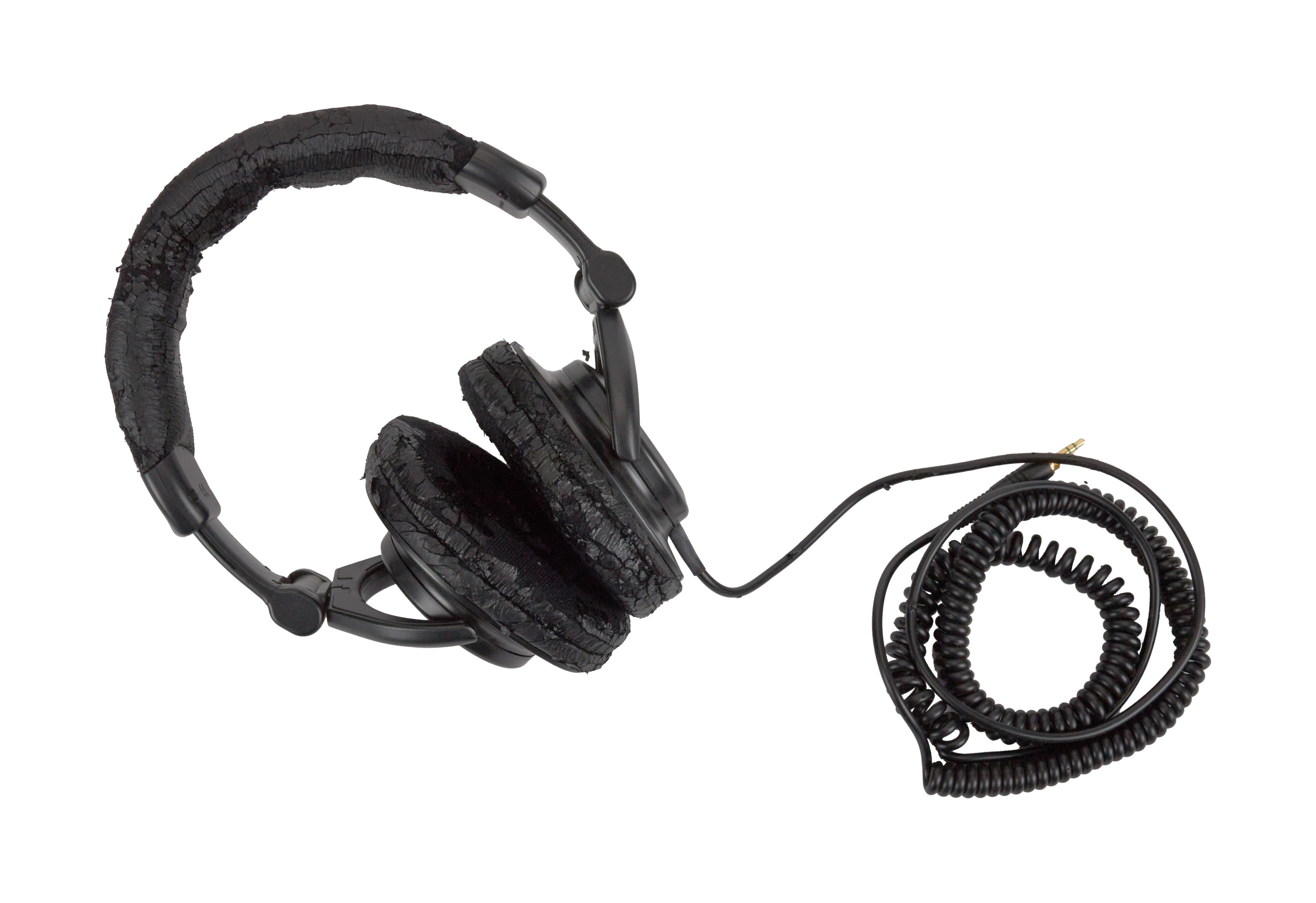 a pair of black headphones with a coiled cord on a white background .