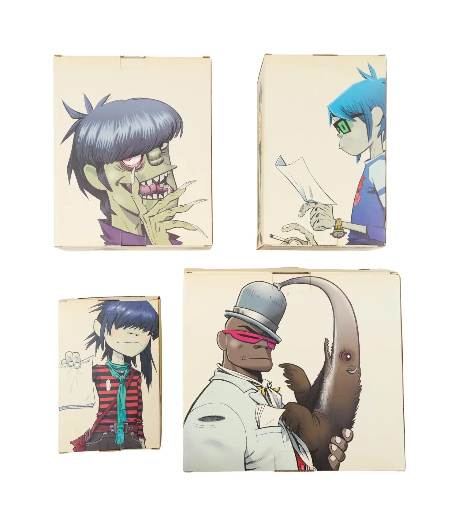 Lot #17. Gorillaz | Stickers, Promo Mobiles, Record Single, DVD, and Complete Set of Kid Robot Figures Four boxes featuring the cartoon characters of Gorillaz: Murdoc, 2-D, Noodle, and Russel Hobbs holding an anteater.
