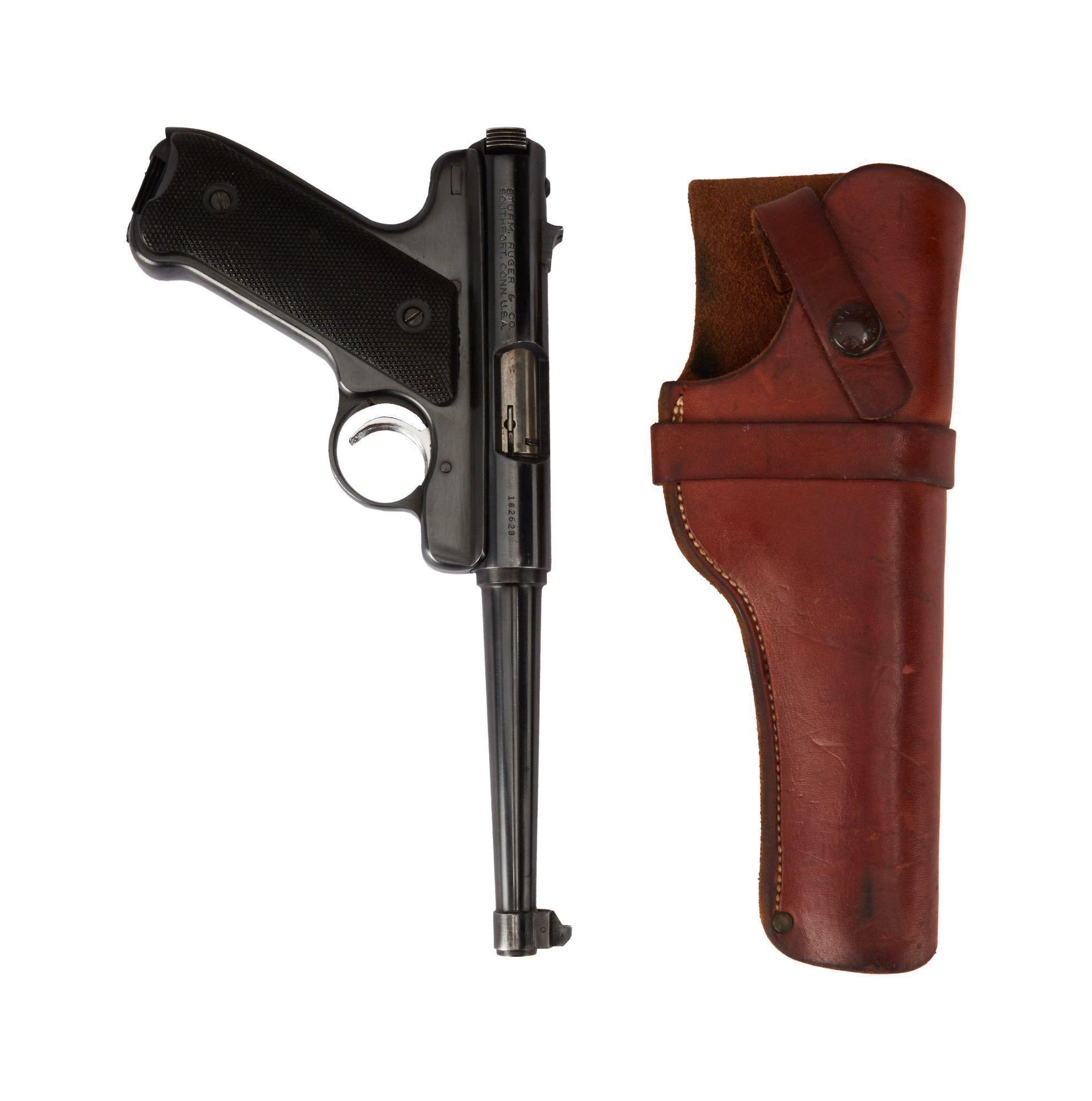 a picture of a black ruger pistol and brown leather holster on a white background
