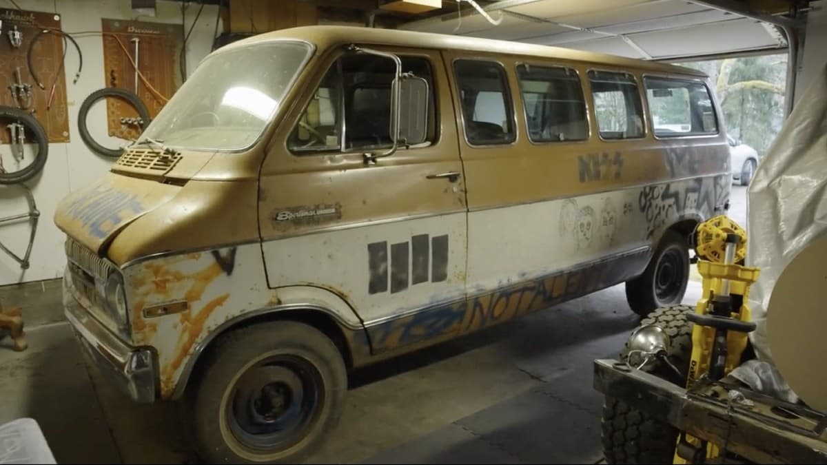 a yellow and white dodge van with graffiti painted on it