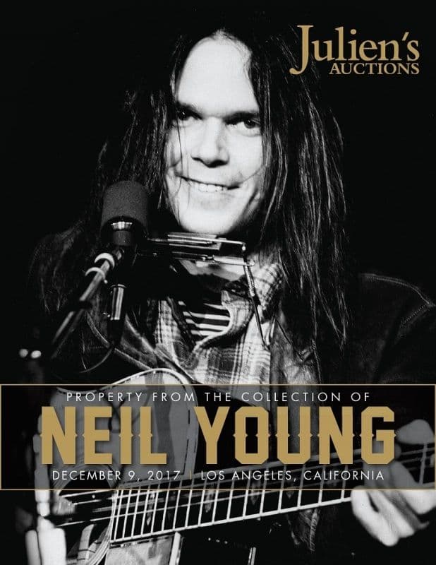 A poster for Julien's Auctions featuring Neil Young