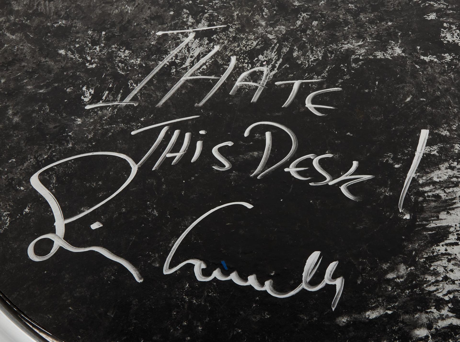 a message that reads i hate this desk signed by simon cowell