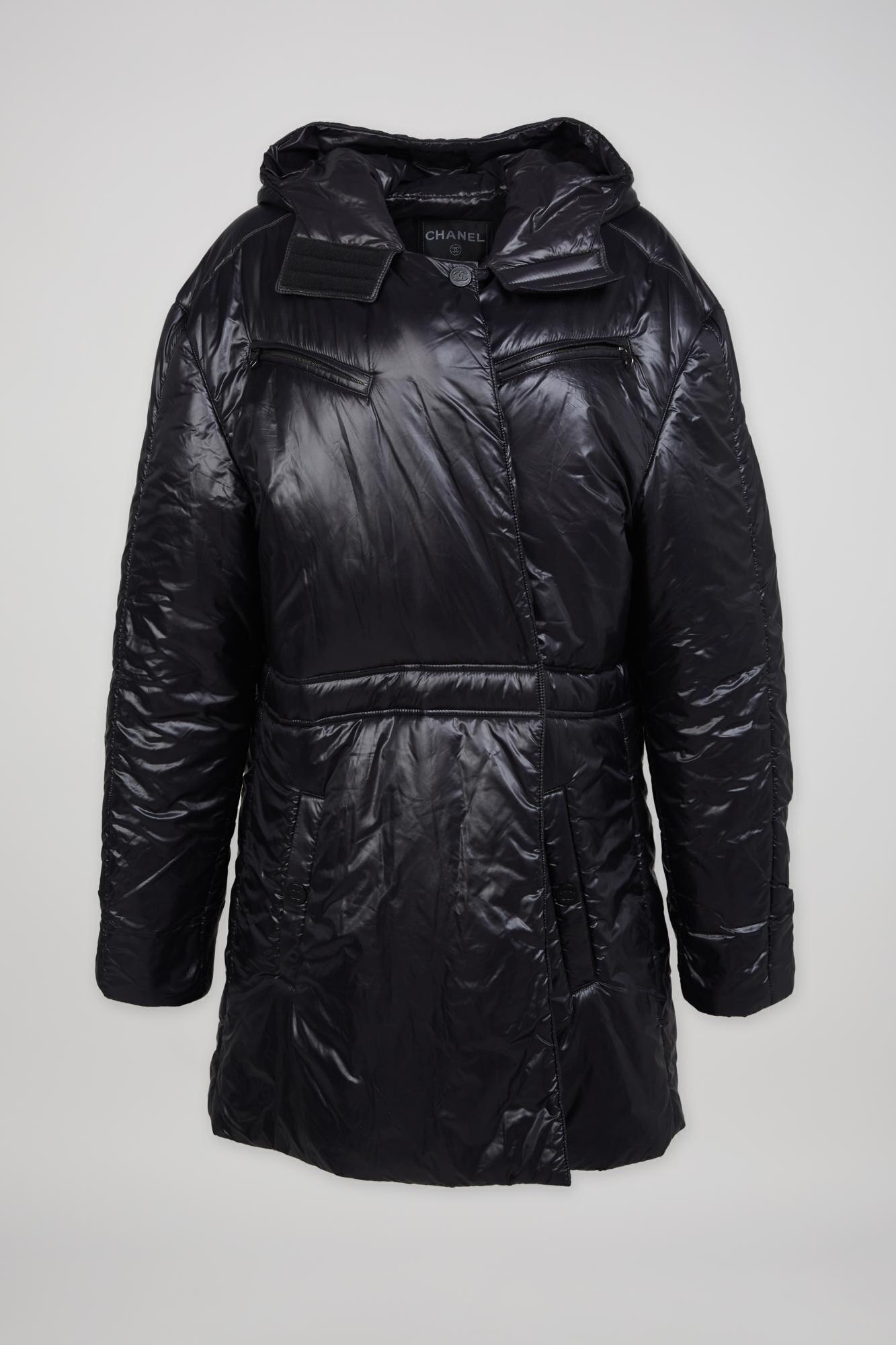 a black chanel coat with a hood on a white background