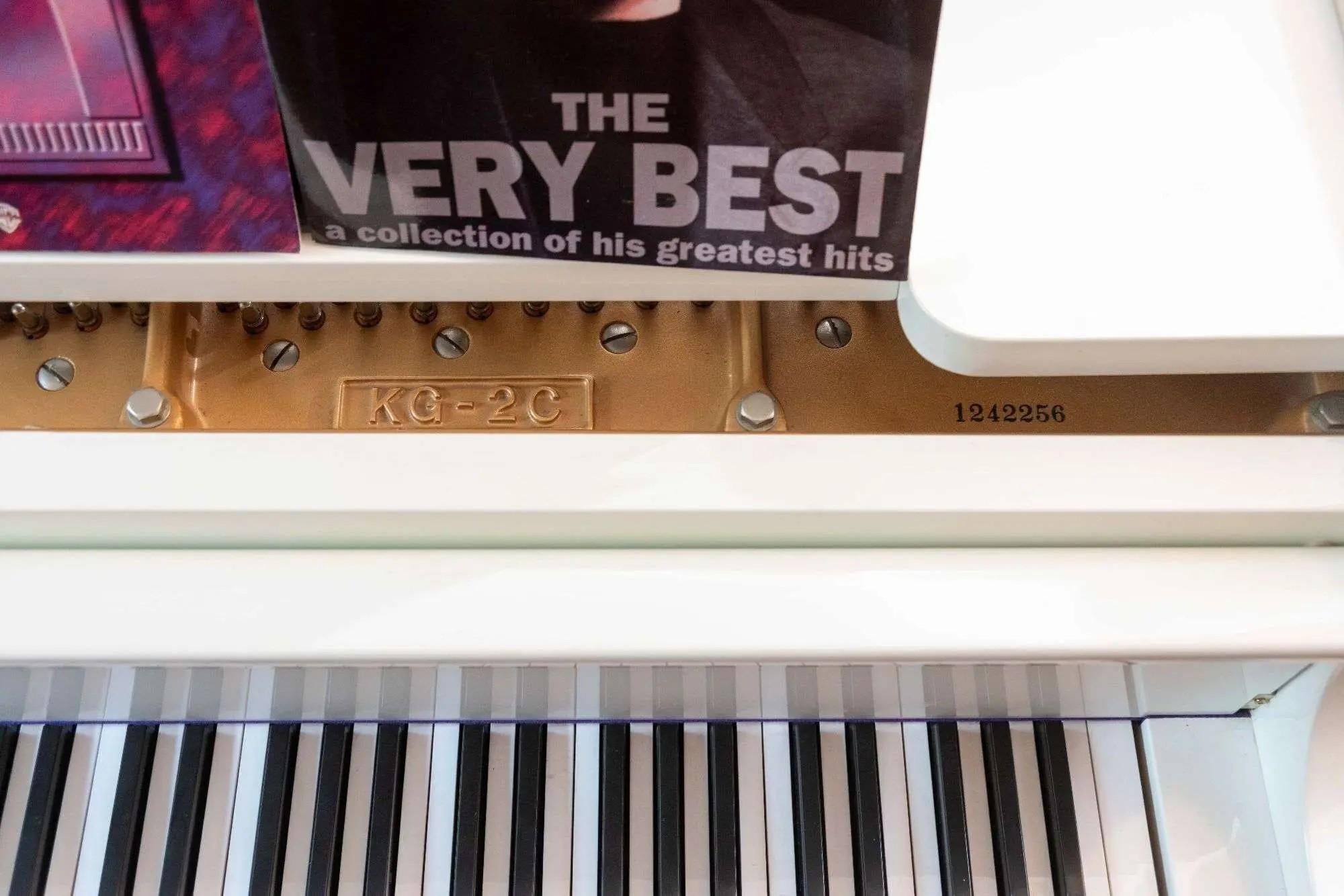 a white K. Kawaii Grand Piano and Bench in the home of whoopi goldberg