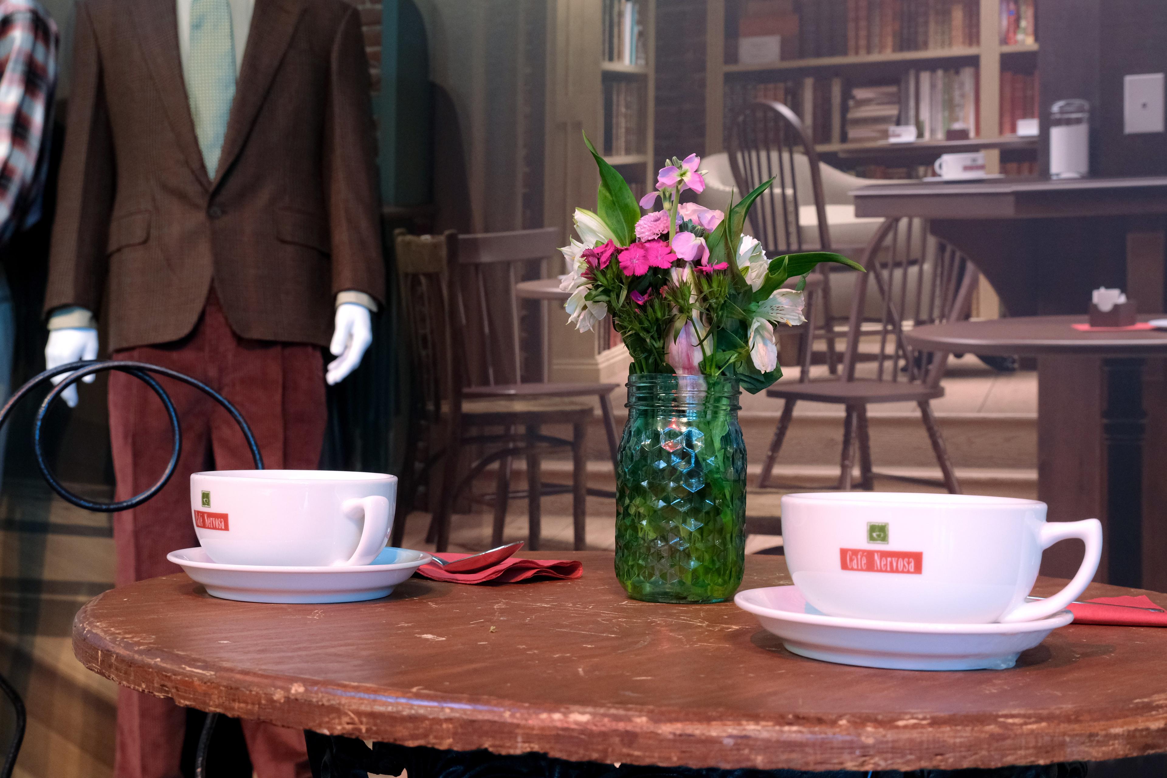 two coffee cups sitting on a table