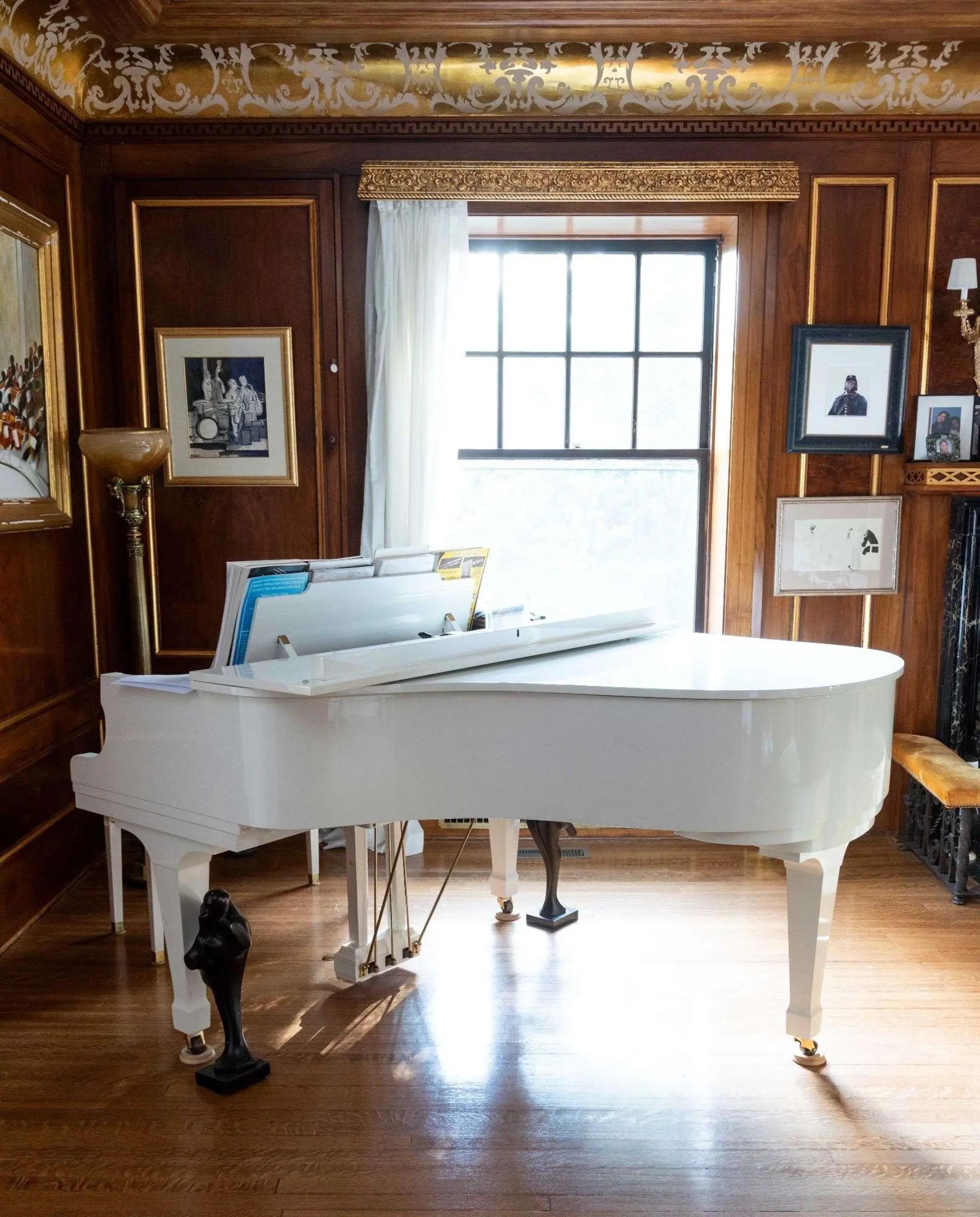 Lot #24. Whoopi Goldberg | K. Kawaii Grand Piano and Bench a white K. Kawaii Grand Piano and Bench in the home of whoopi goldberg
