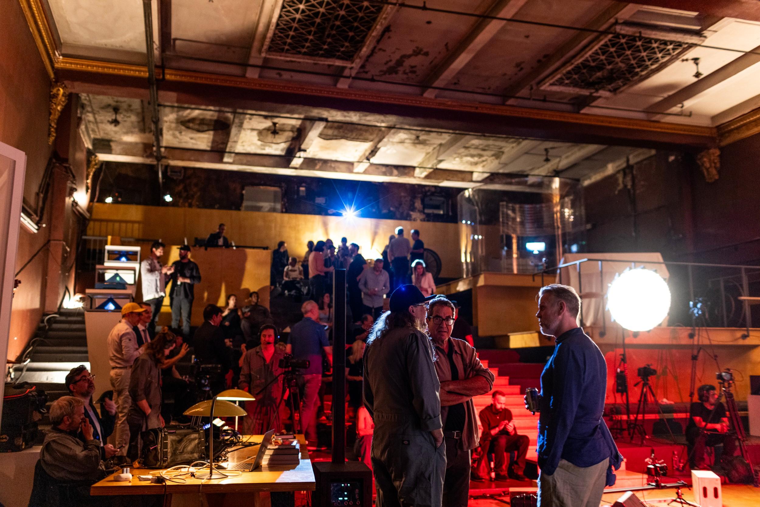 a group of people are standing in a large room .