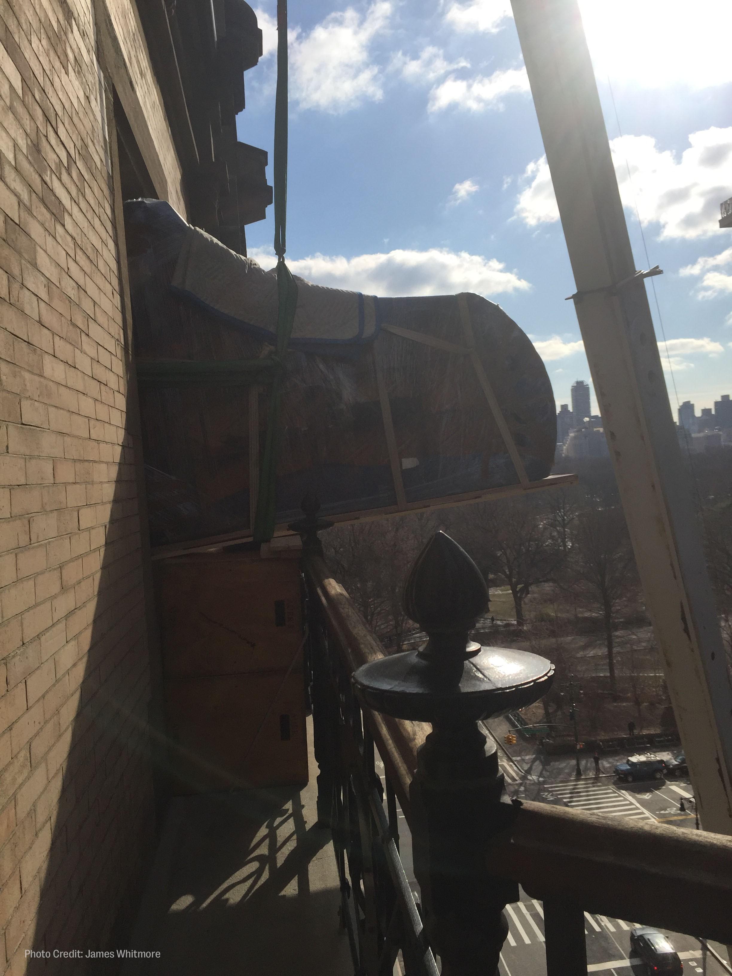 workers hoist roberta flack's piano out of her new york city apartment window.