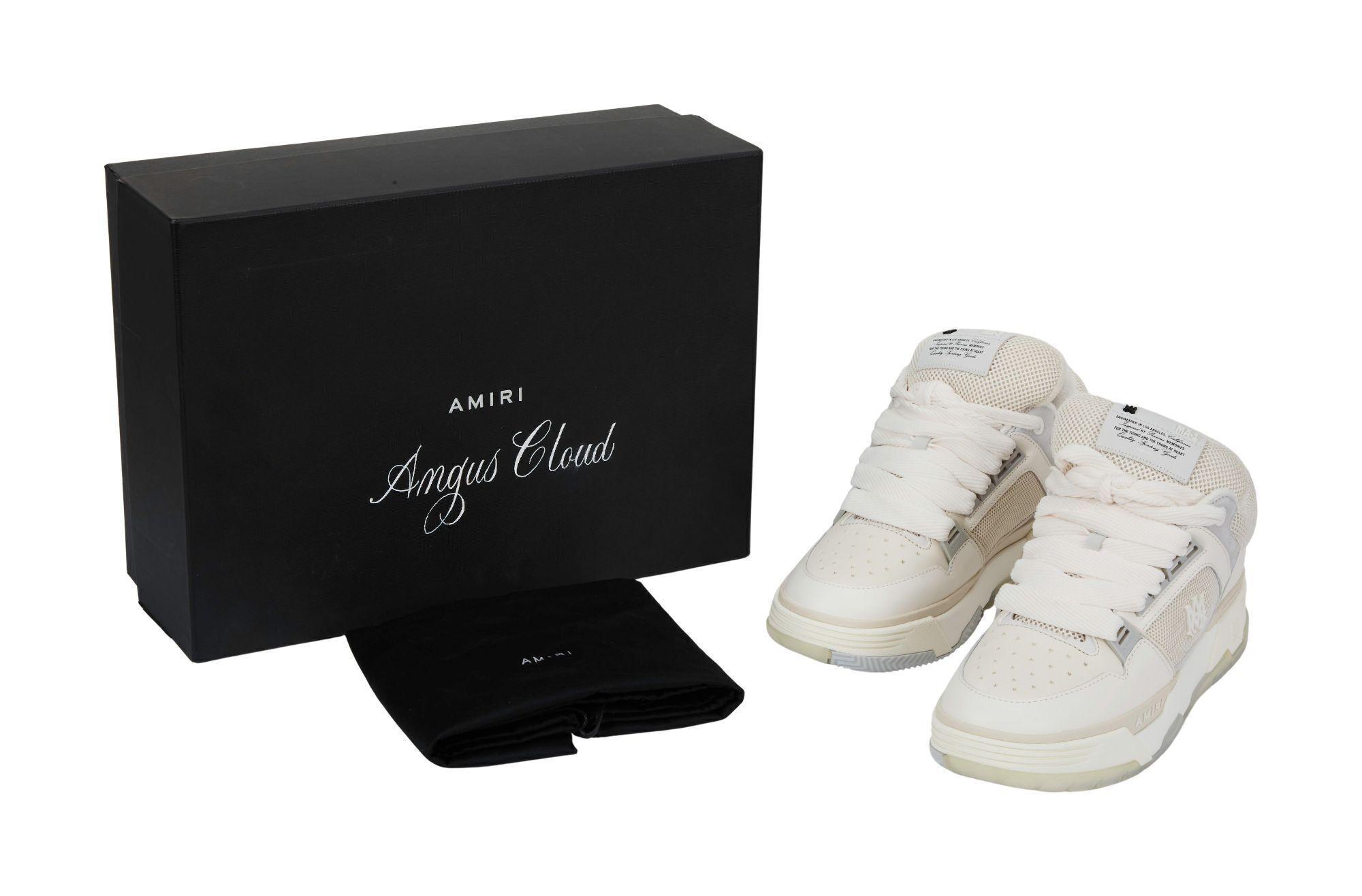 Lot #465. Angus Cloud | Amiri Sneakers With Box a pair of white sneakers are sitting next to a black box .
