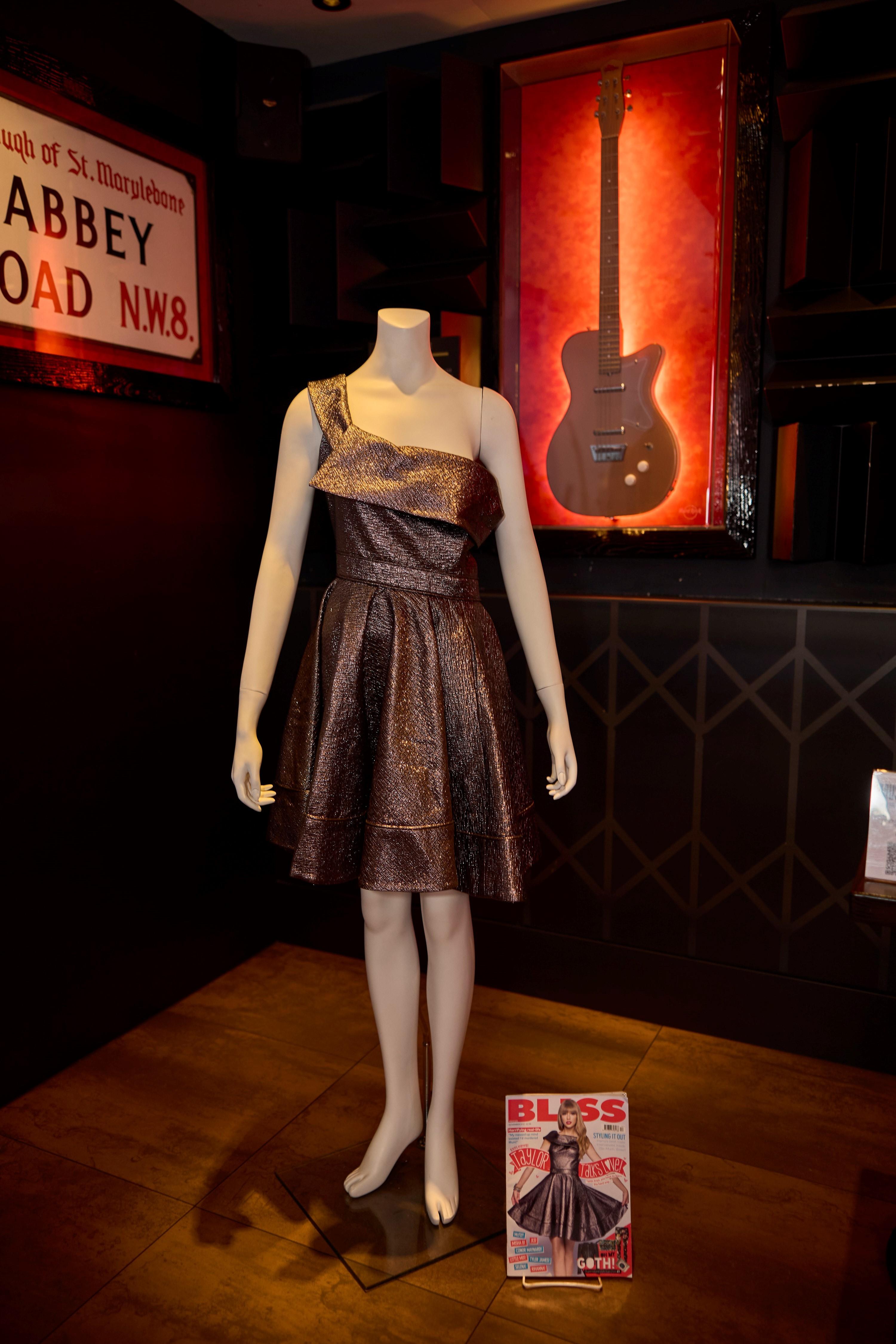a copper colored dress on a mannequin