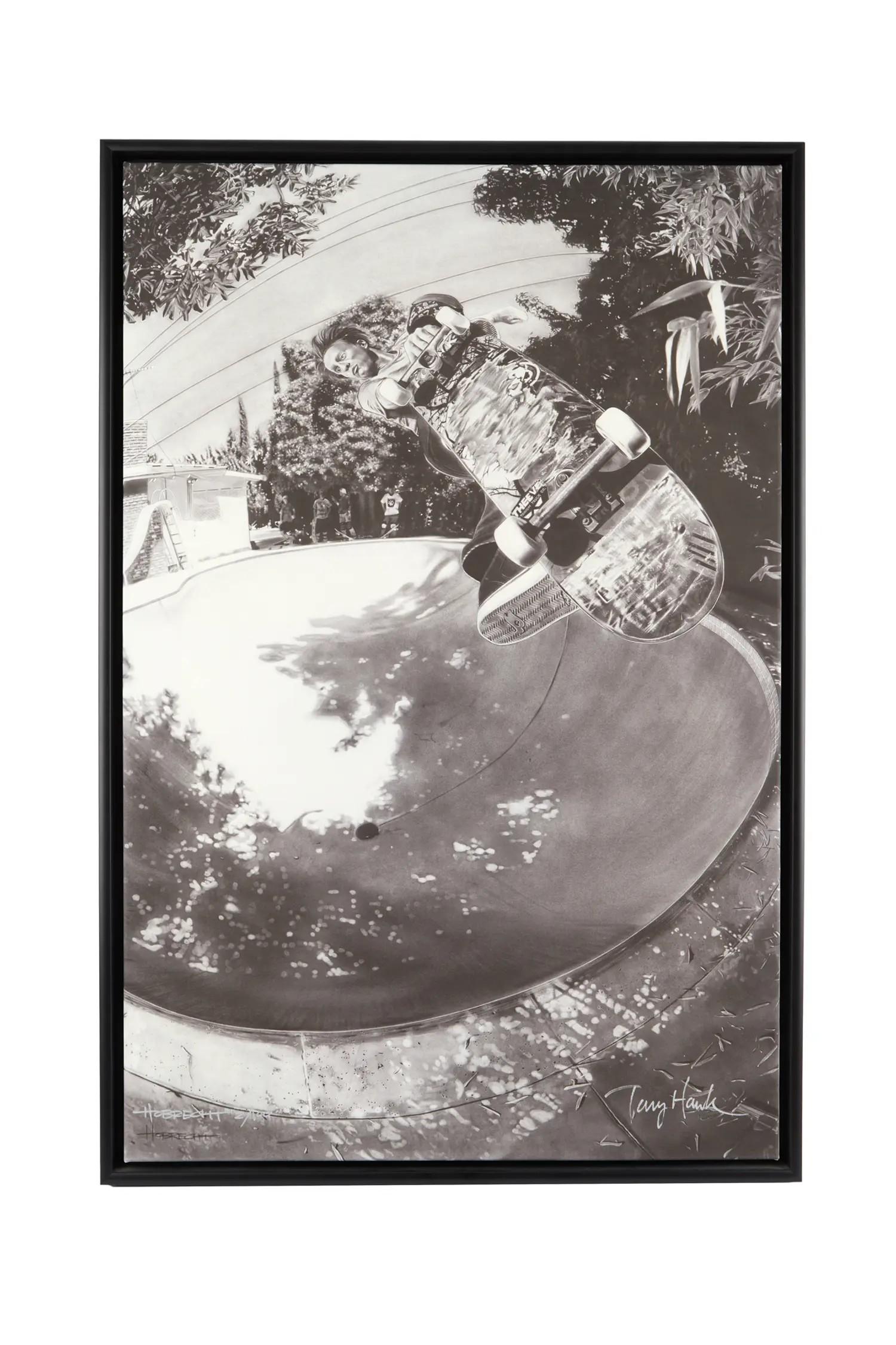 Lot #45. Tony Hawk and Dave Hobrecht | Signed Limited-Edition Print Framed black and white photo of Tony Hawk mid-air over a skate bowl, signed.