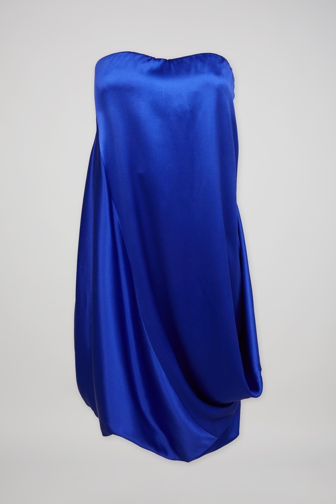 a blue strapless dress with a draped skirt on a white background