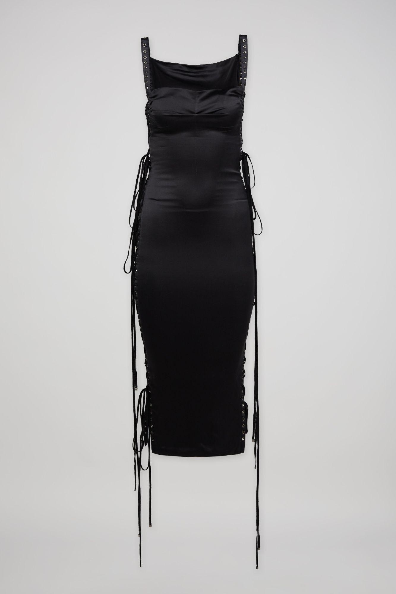 a black satin dress with lace up sides is on a white background .