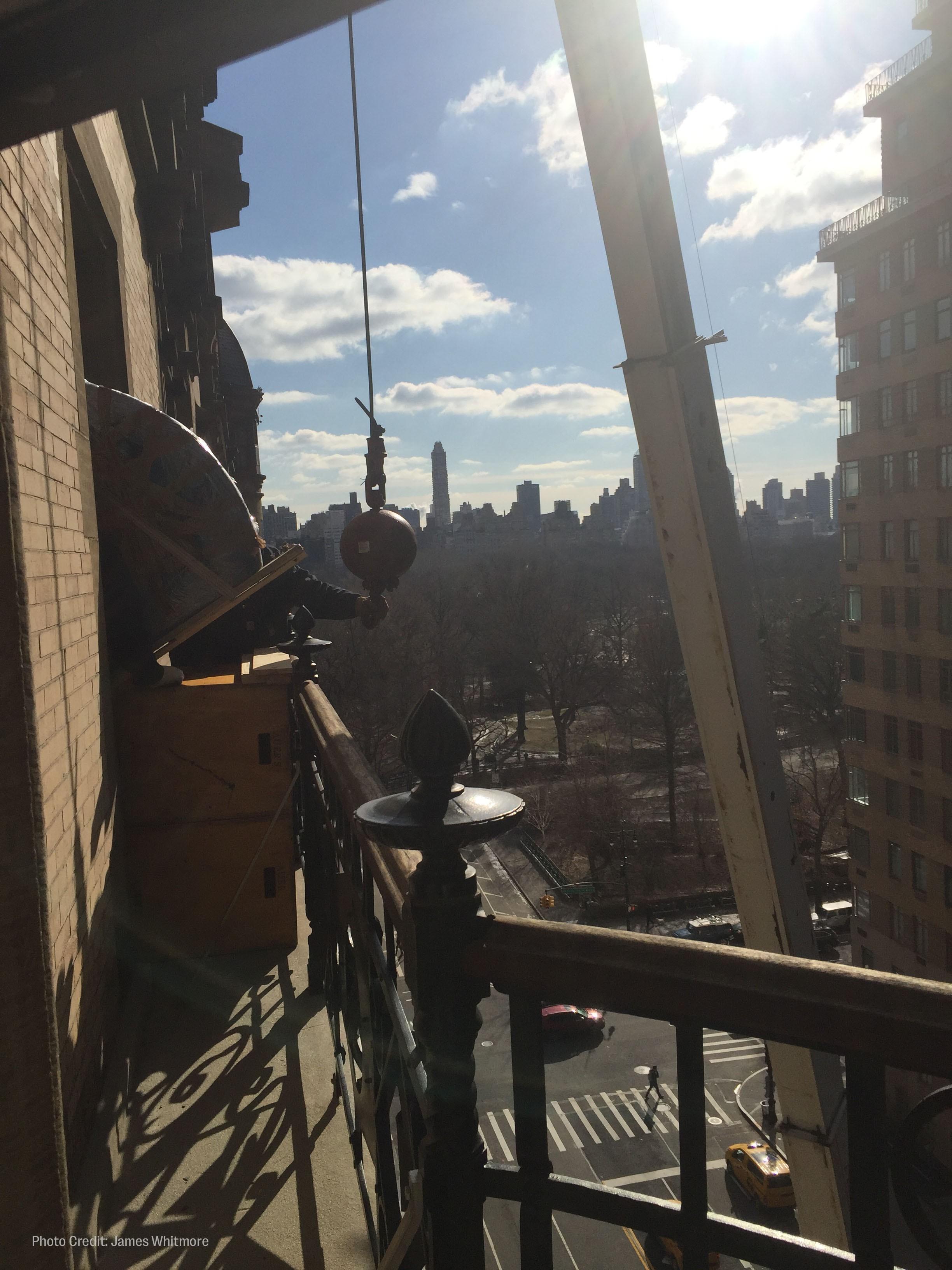 workers hoist roberta flack's piano out of her new york city apartment window.