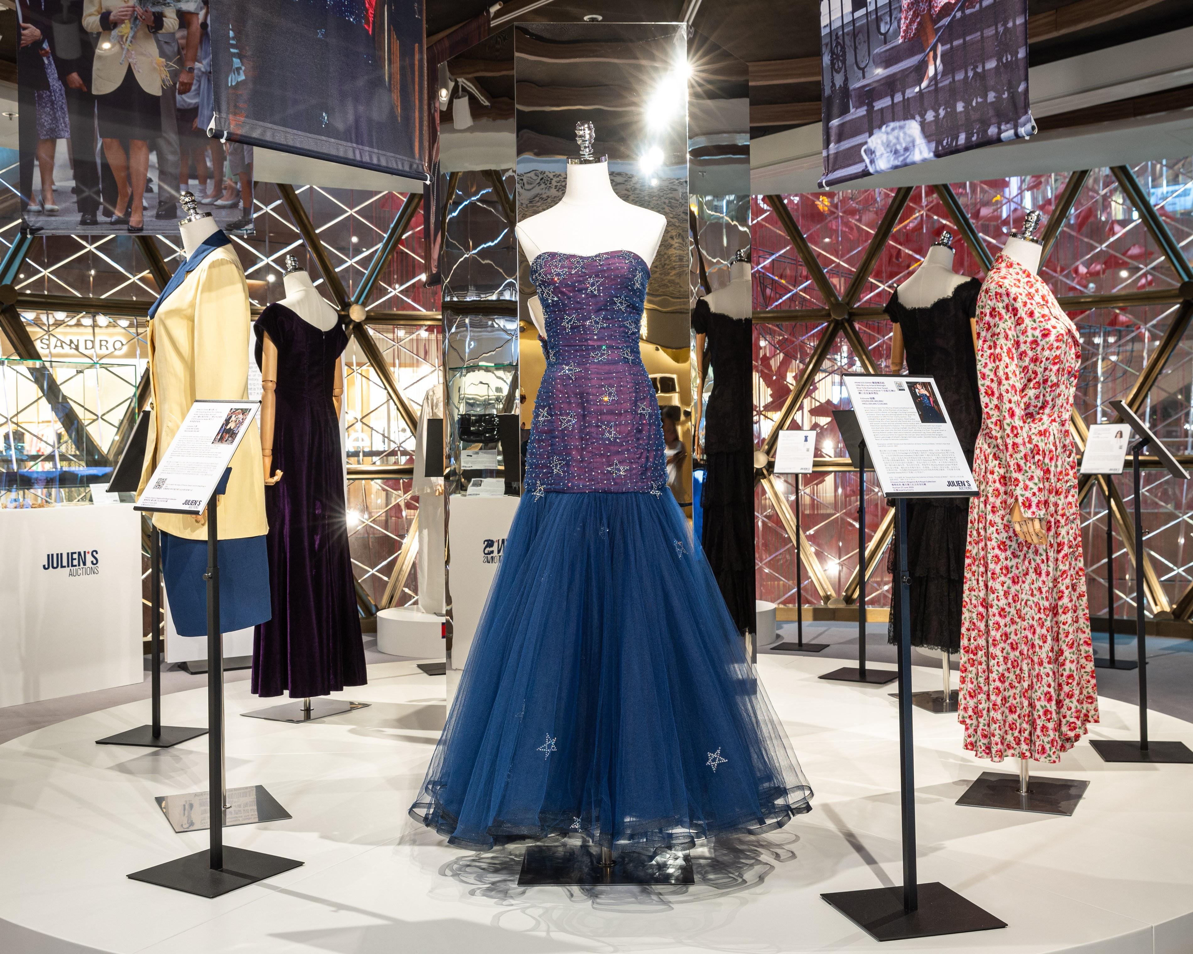 Dresses on mannequins arranged in a circle.