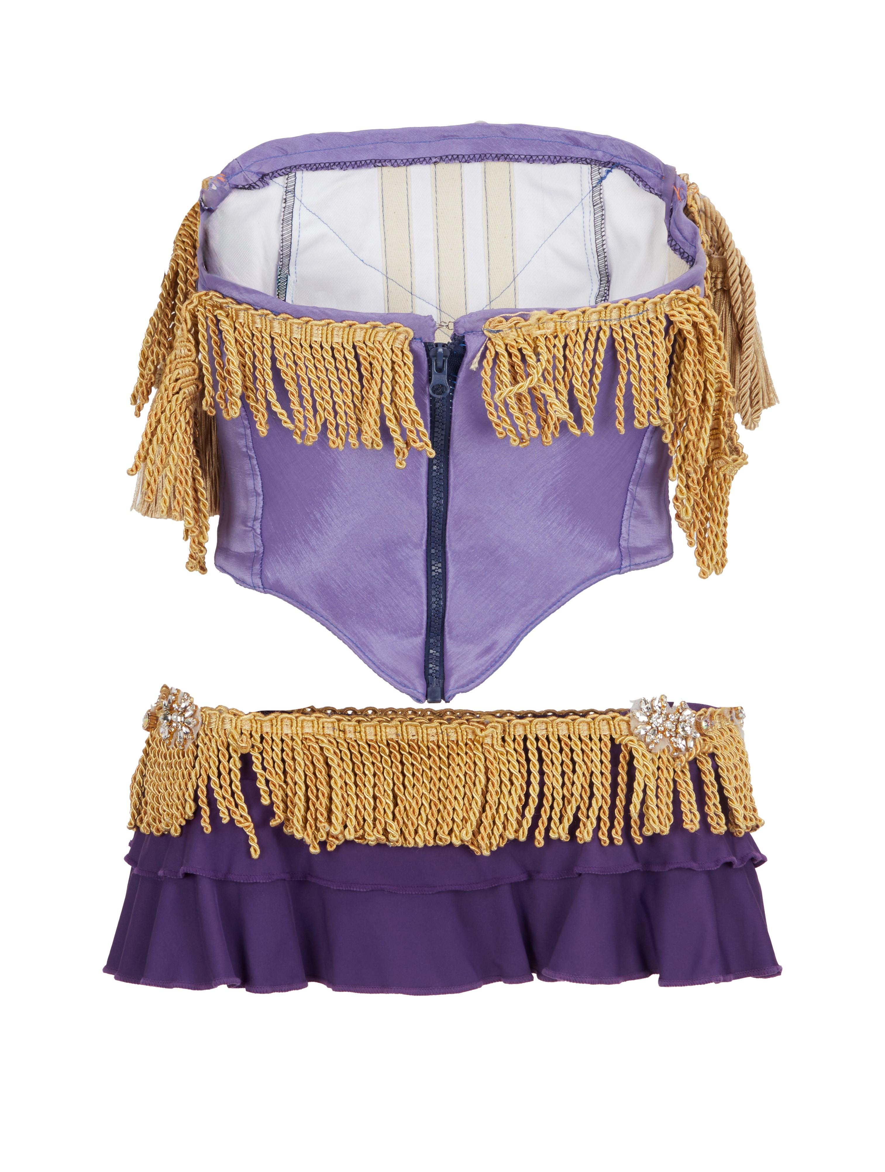 a purple top with gold fringe and a gold skirt
