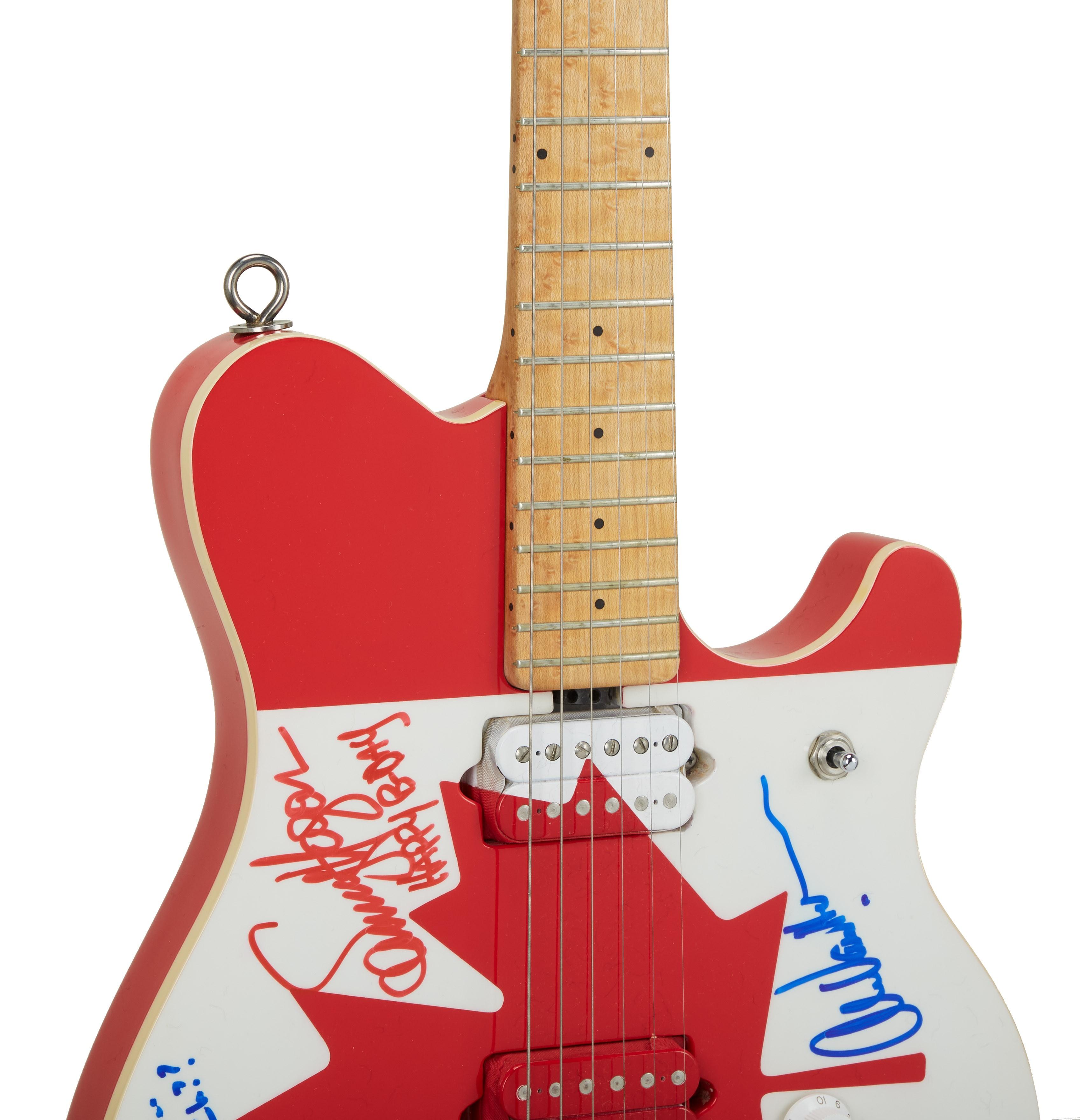 a red and white electric guitar with signatures on it