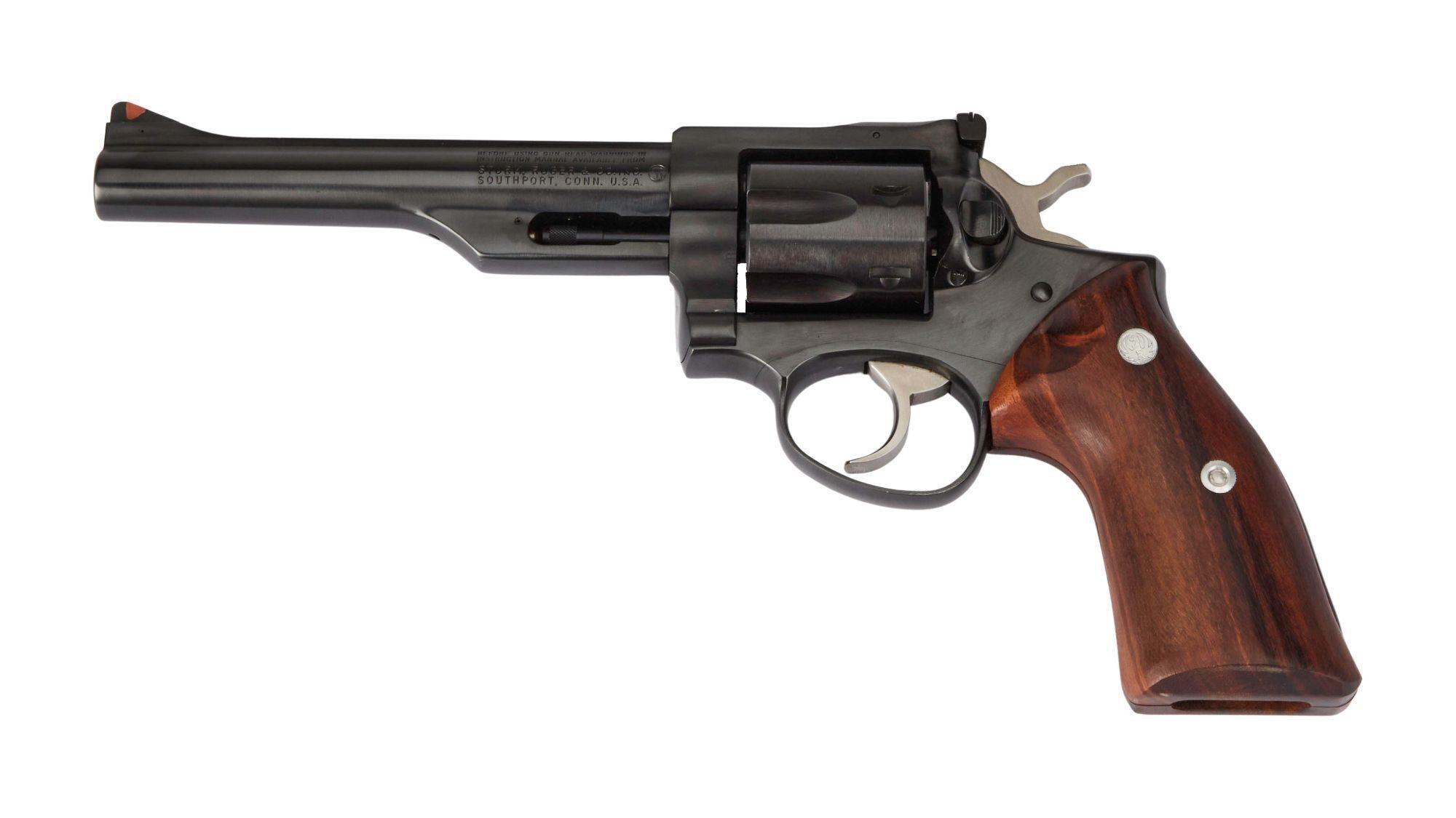 a black revolver with a wooden grip on a white background .