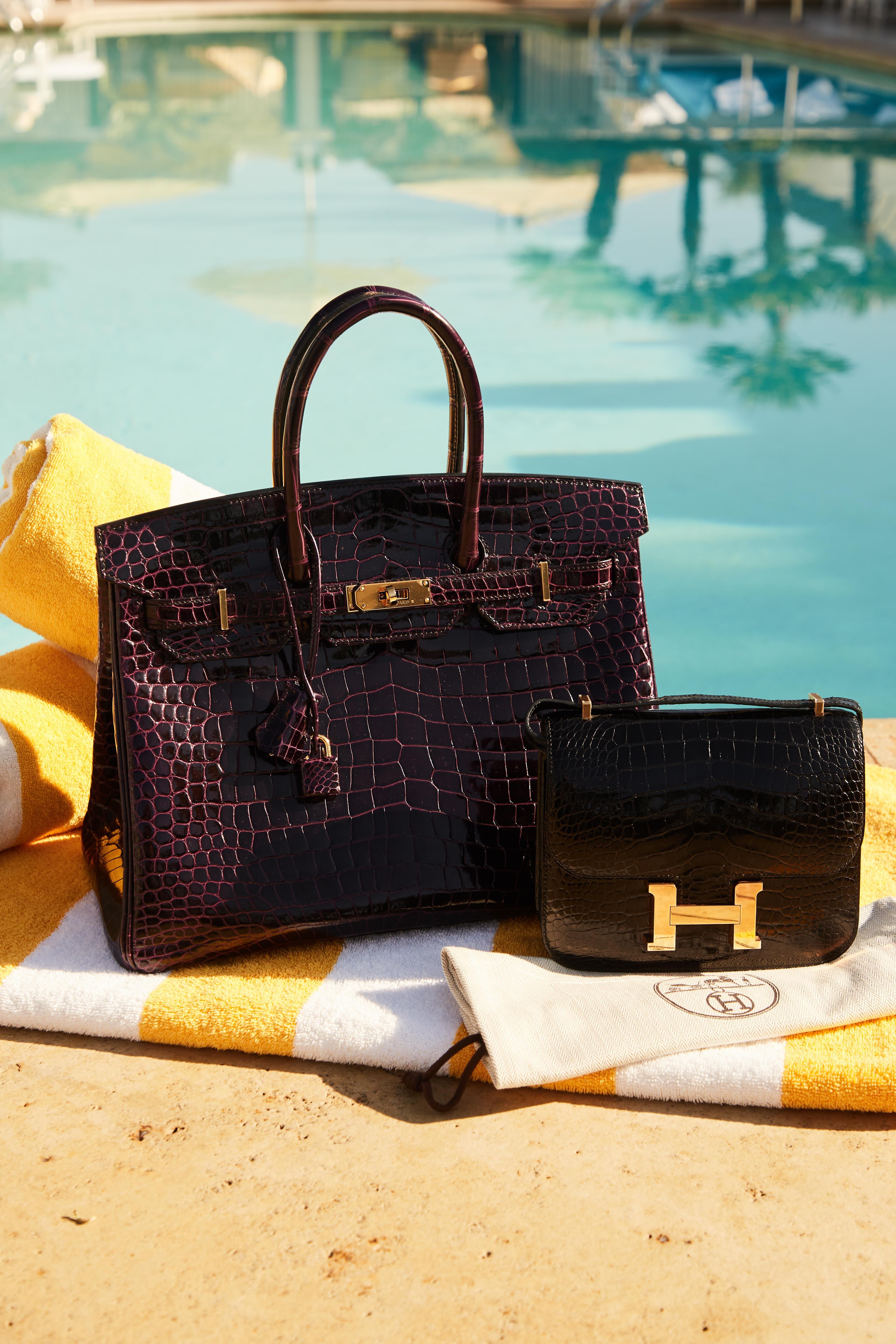 a black purse with the letter h on it