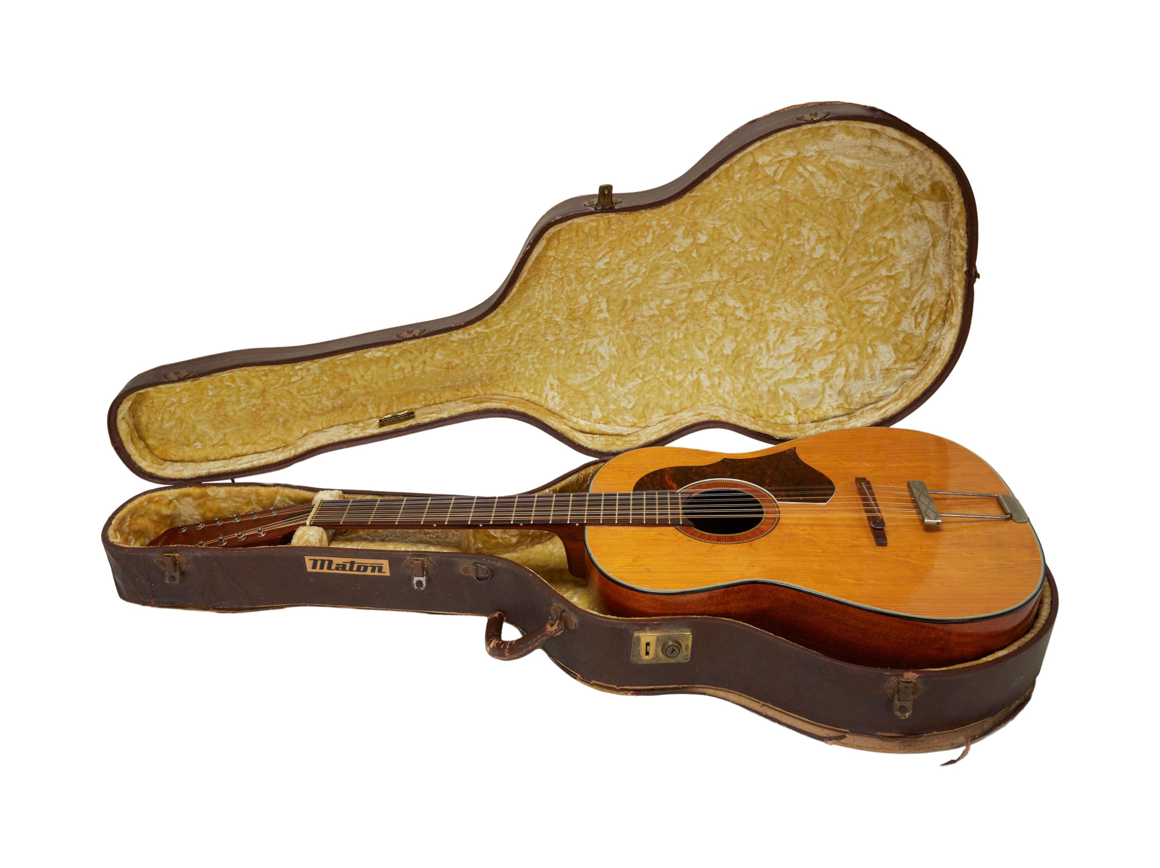 a guitar in a case that says maton on it
