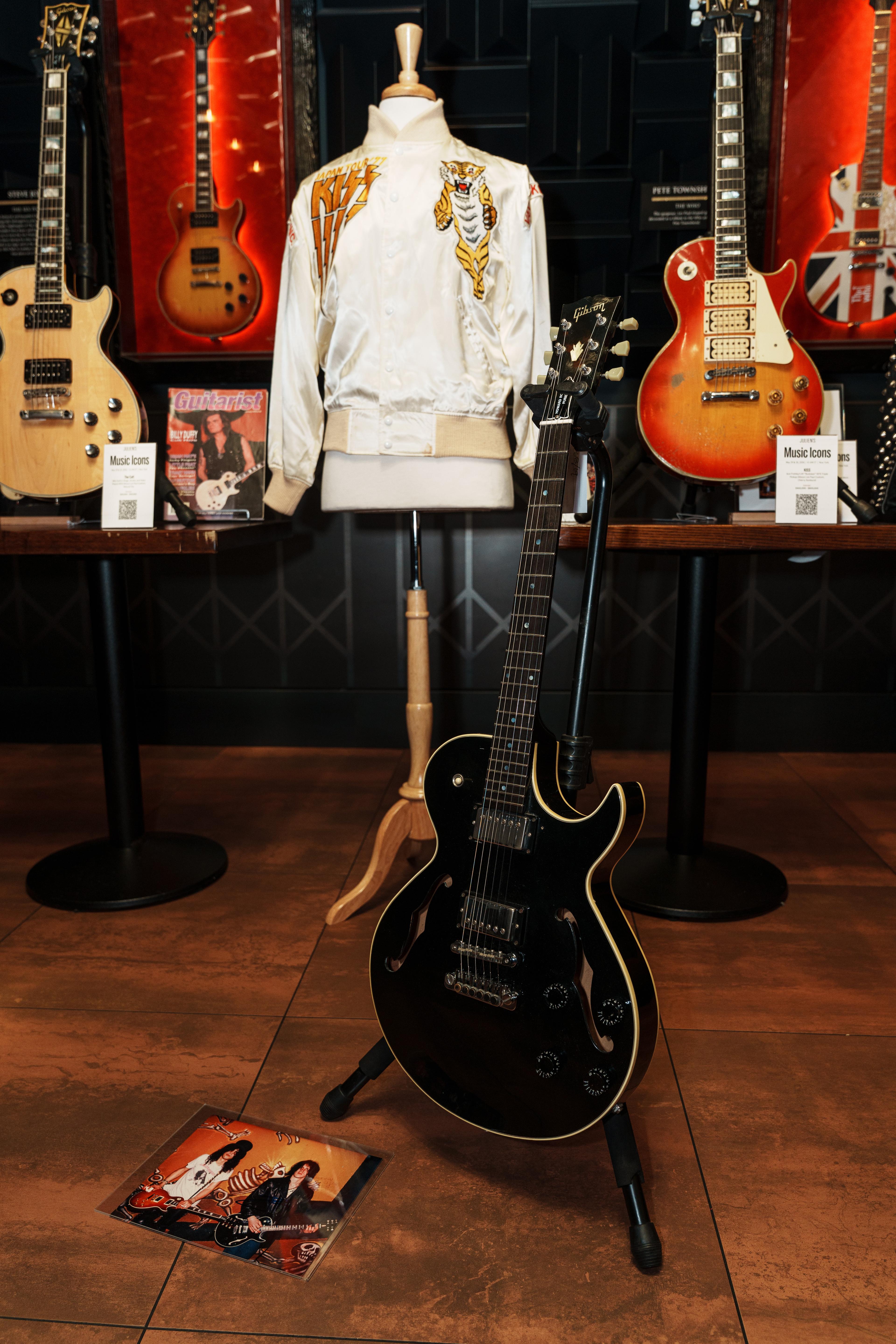 black guitar with white jacket